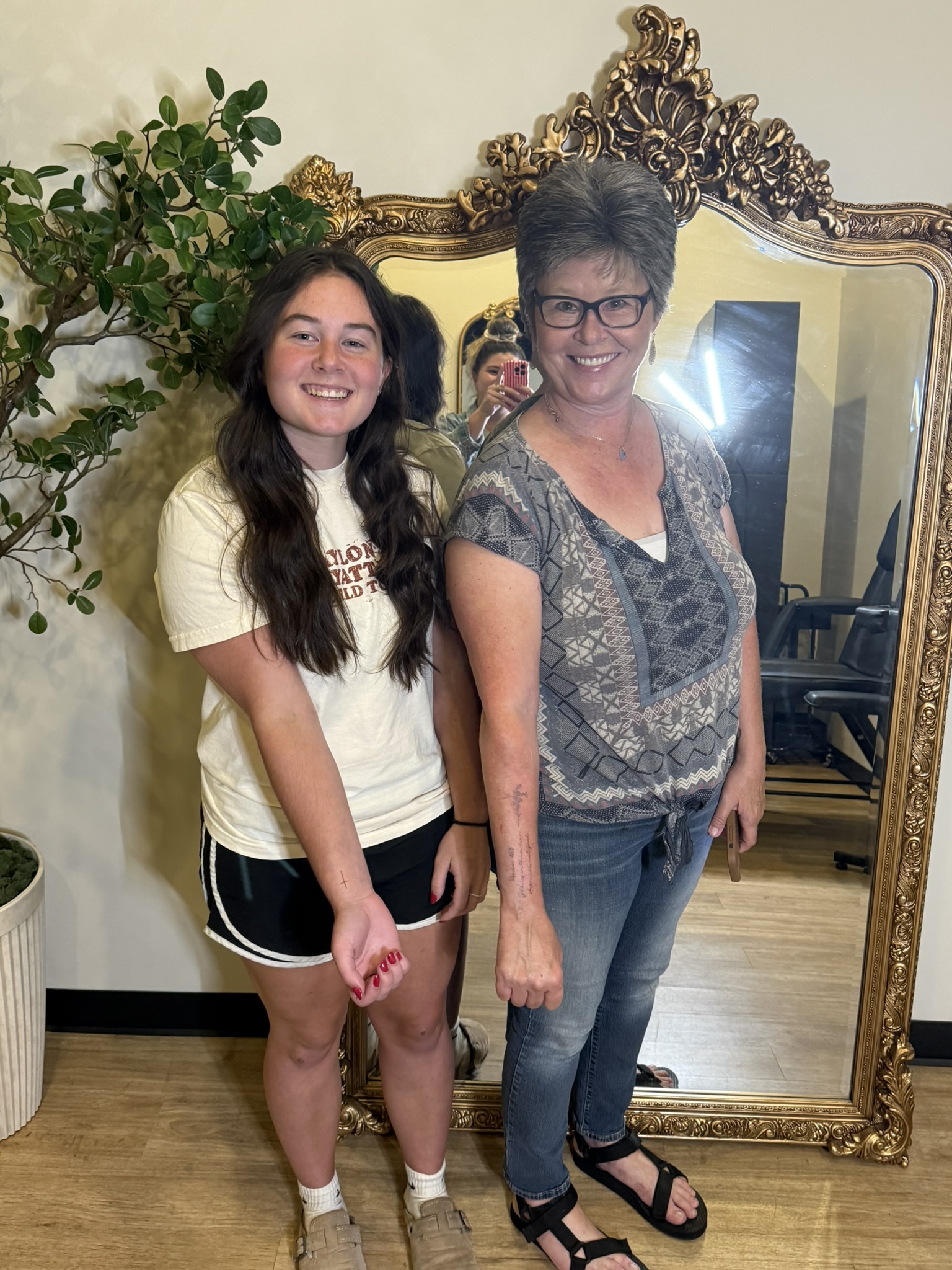 Mother and daughter clients at a private fine line tattoo studio in Beavercreek, Ohio