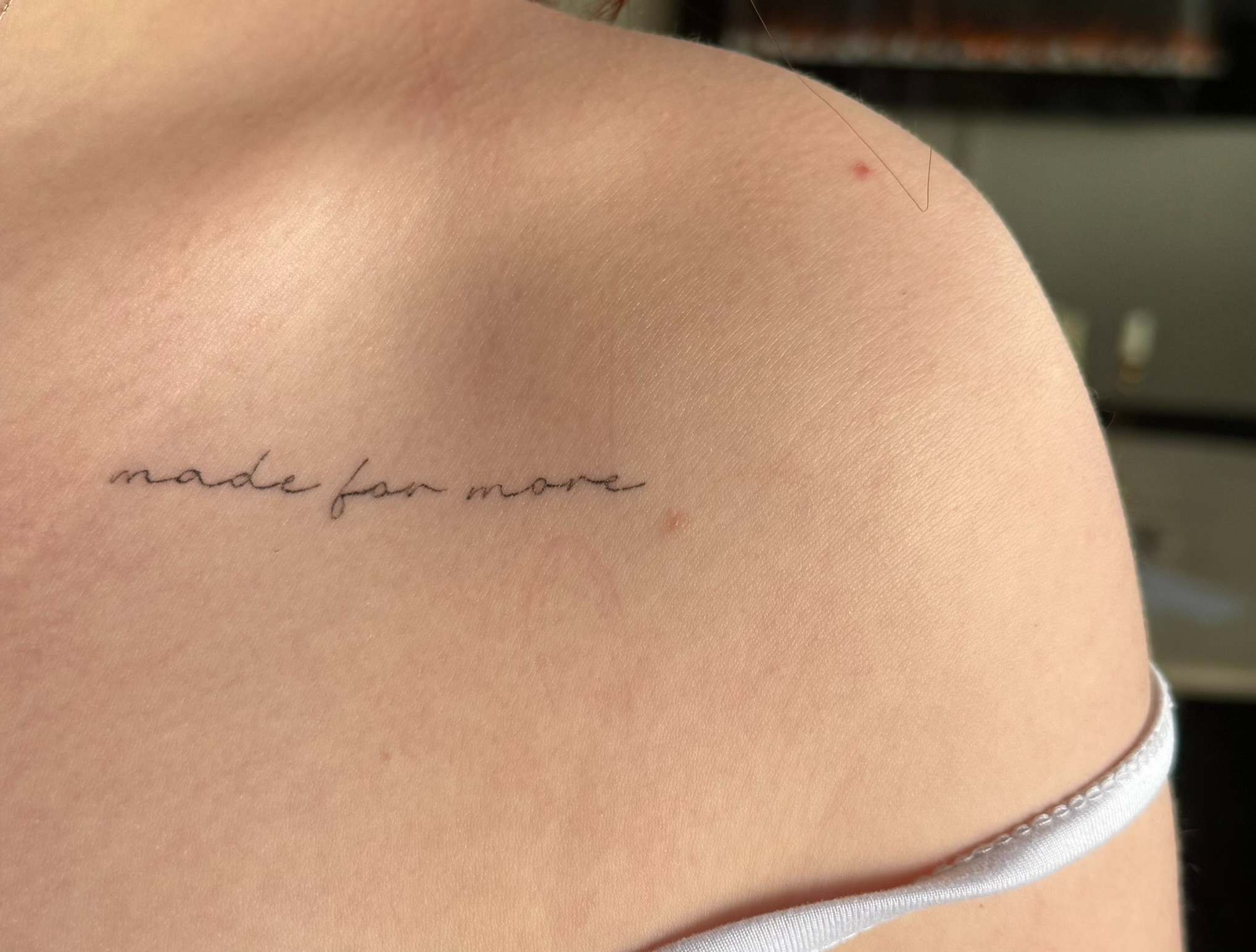 Healed fine line script tattoo