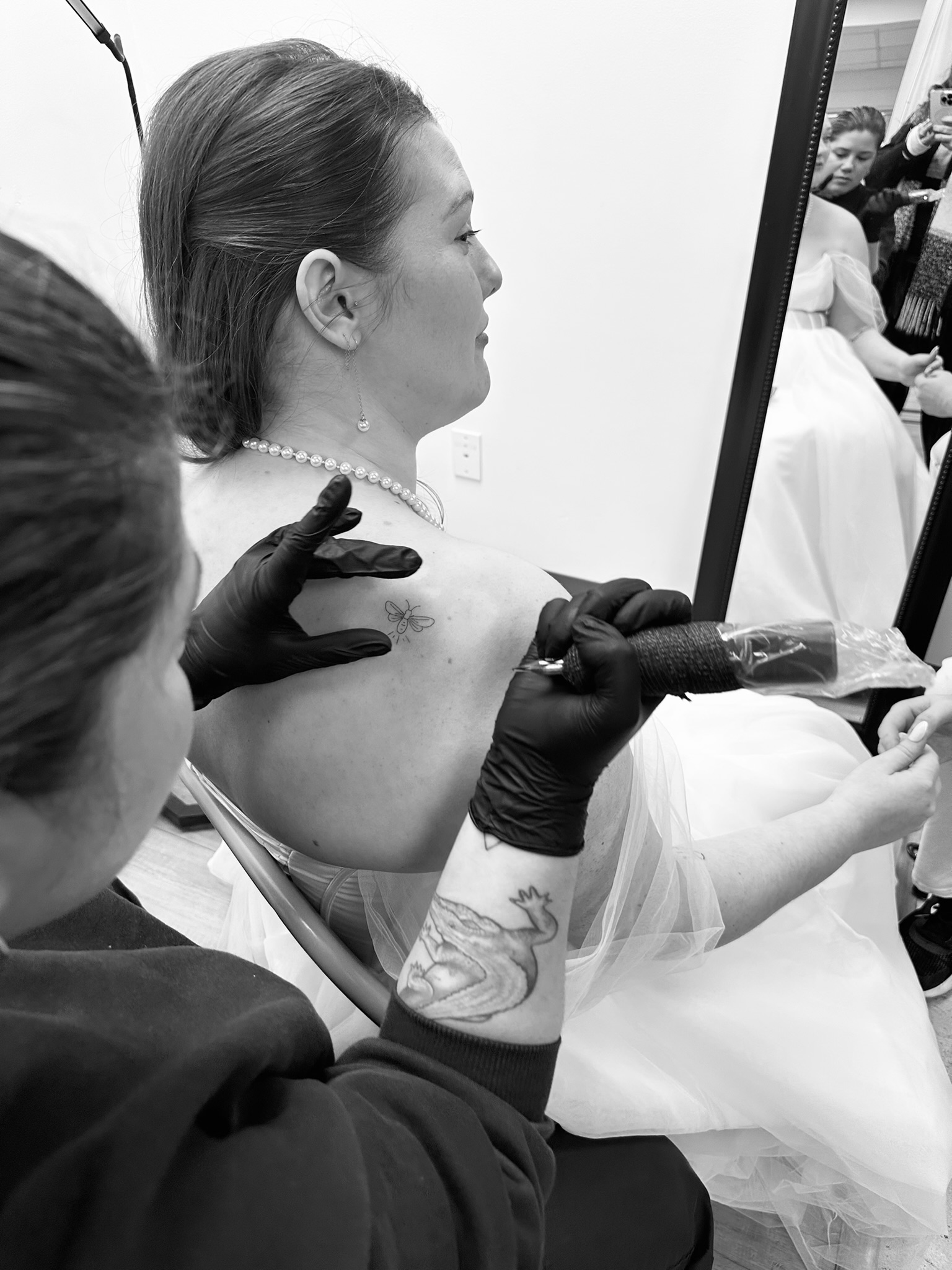 Clarissa Victoria Rosa, mobile fine line tattoo artist, working at a luxury wedding tattoo booth in Ohio