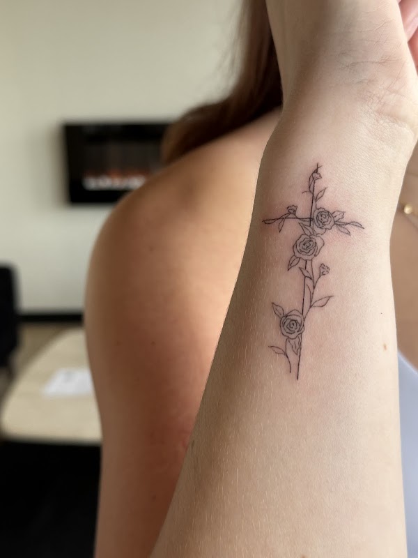 Fresh floral cross fine line tattoo by Clarissa Victoria Rosa in Beavercreek, Ohio.
