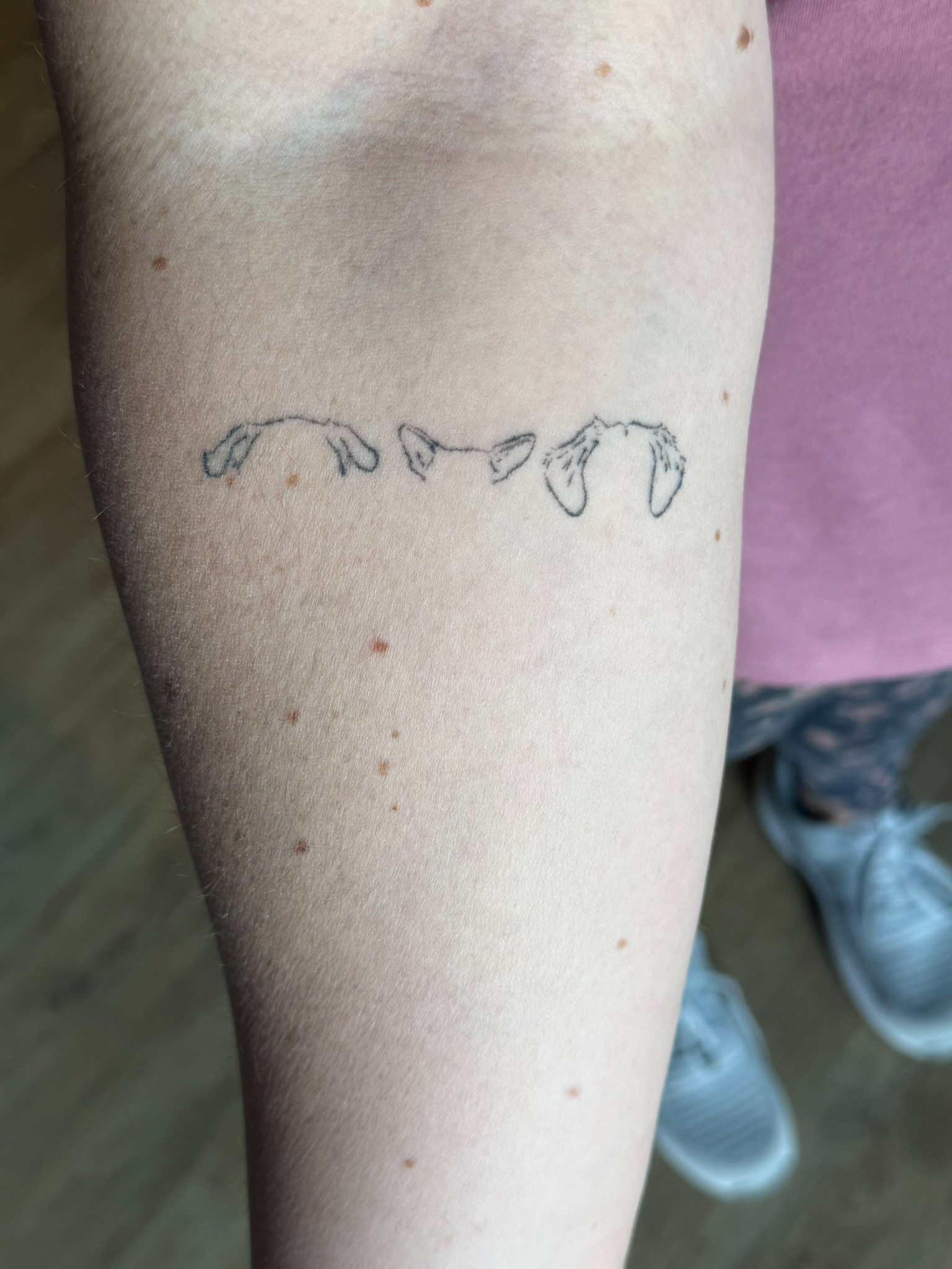 Healed fine line pet ears tattoo