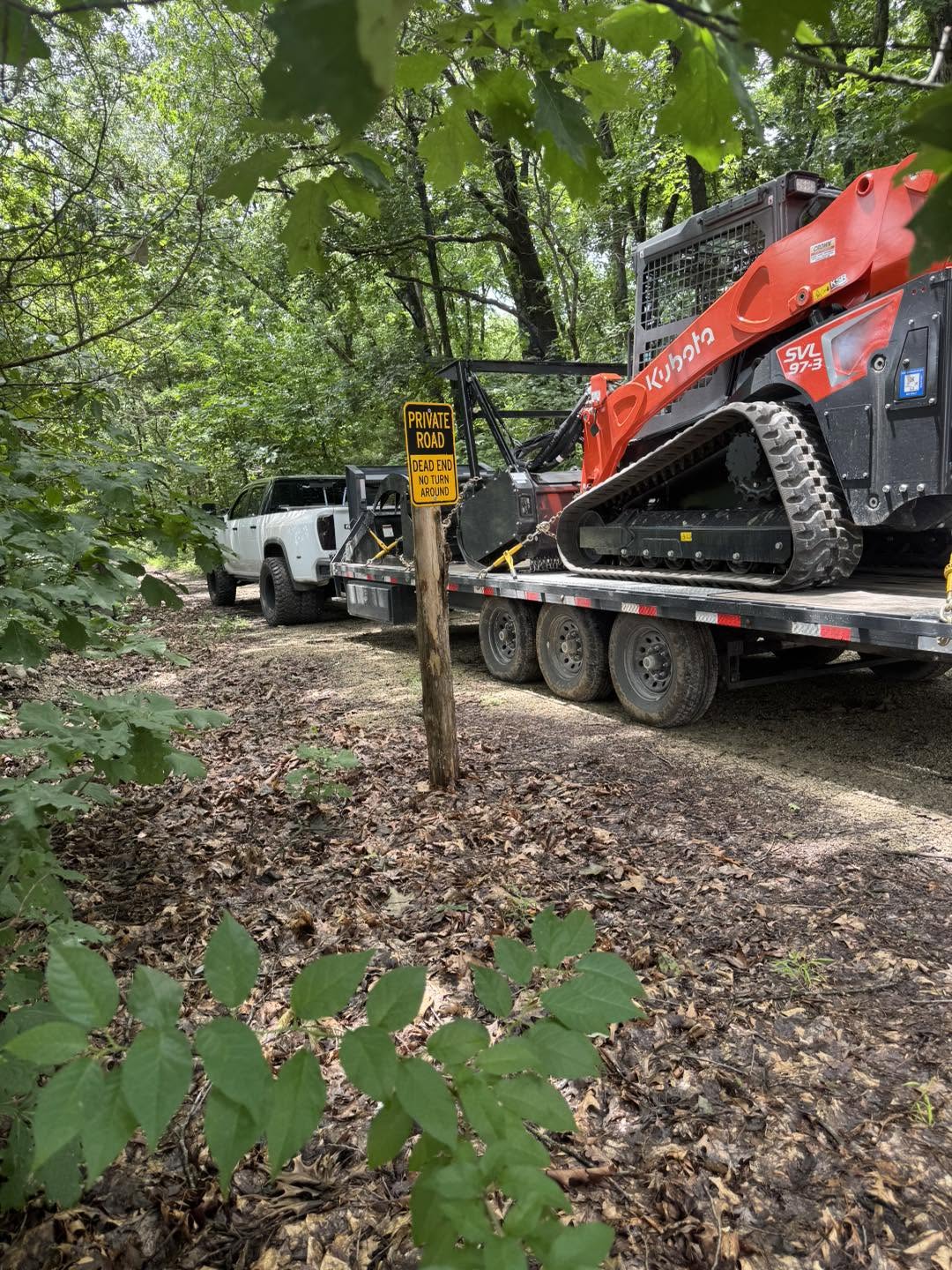 Kubota SVL97 on trailer arriving at job site
