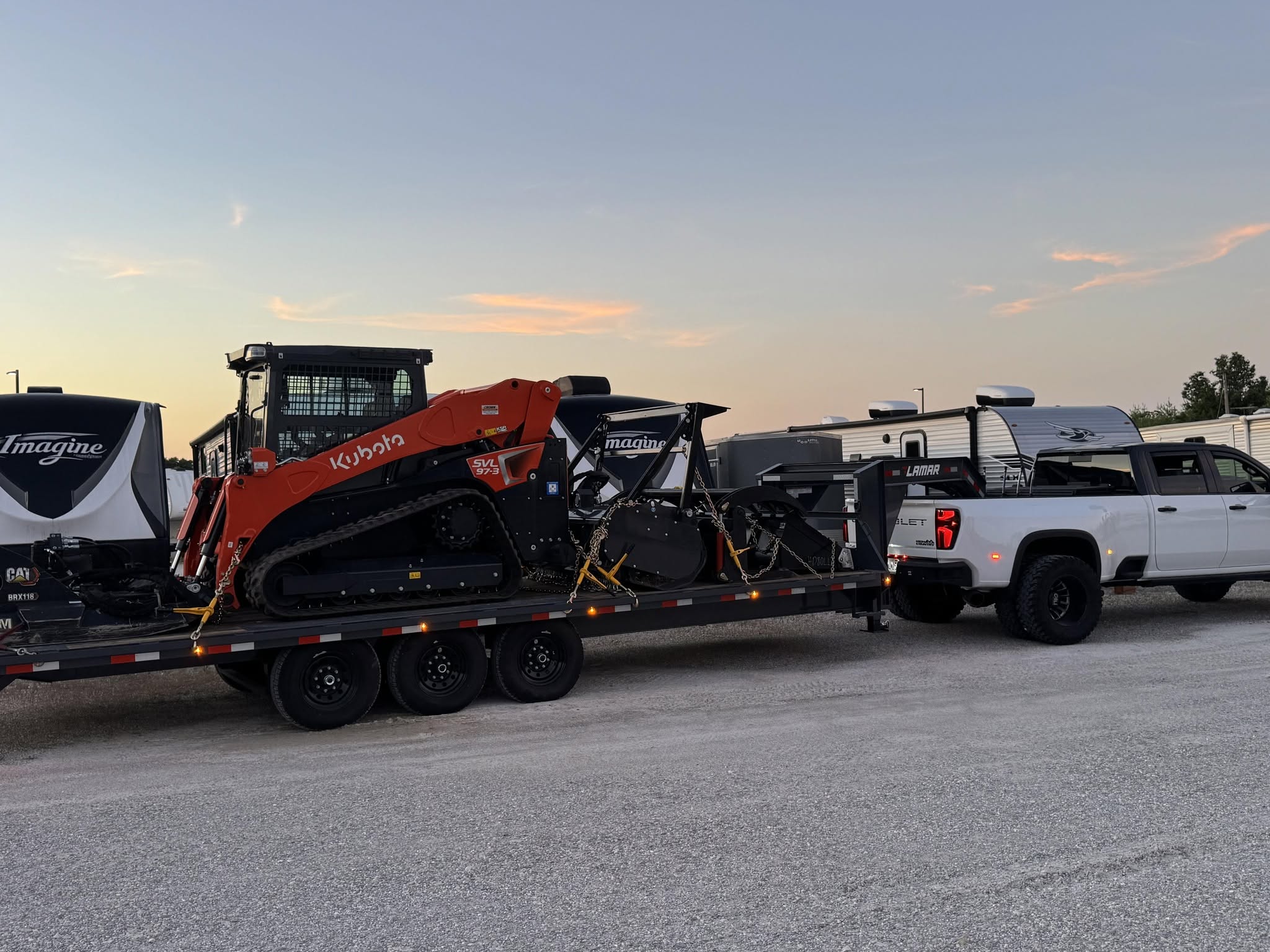 Kubota SVL97 on trailer at sunset ready for next job