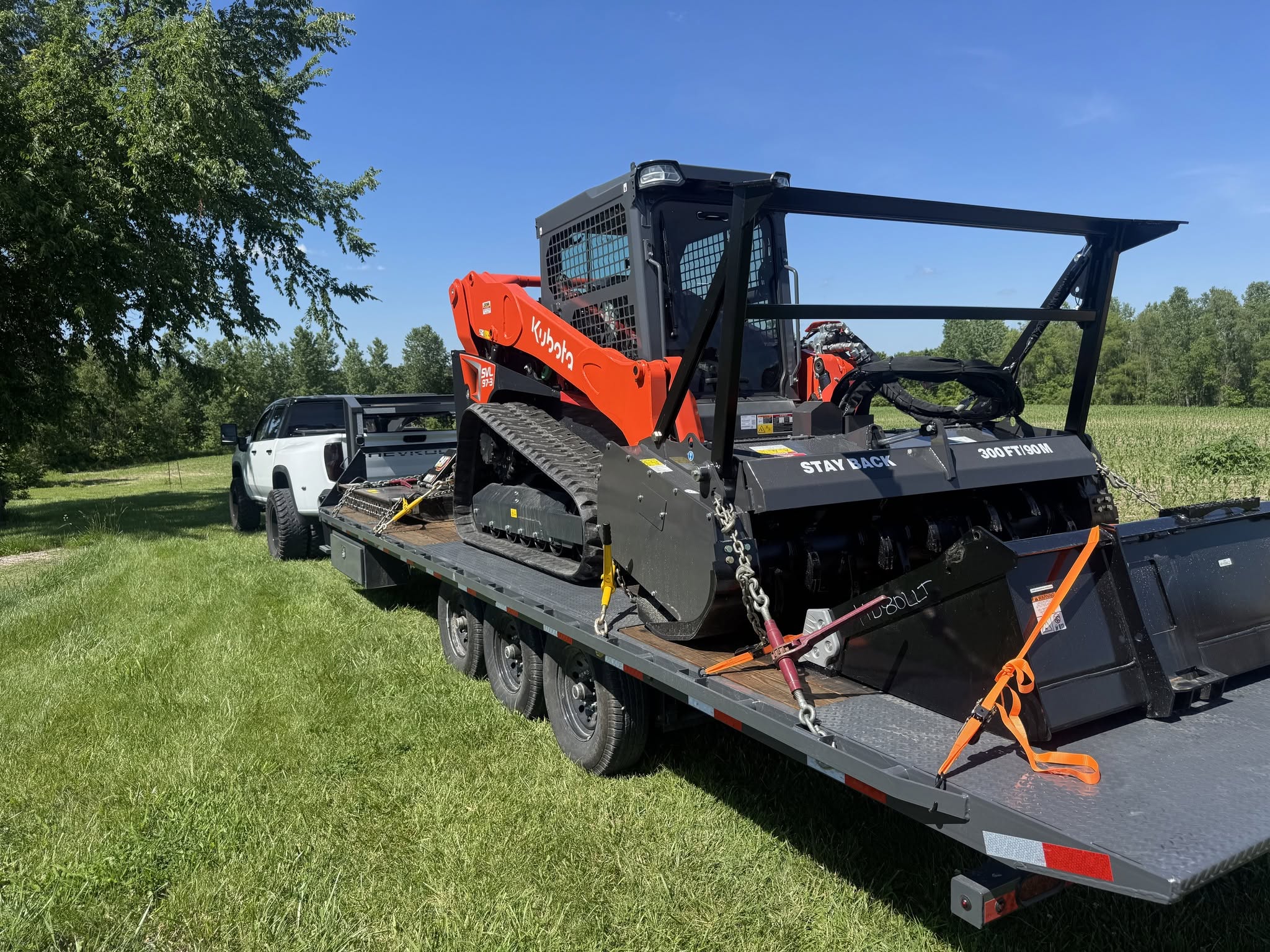 Kubota SVL97 on flatbed trailer arriving at job site