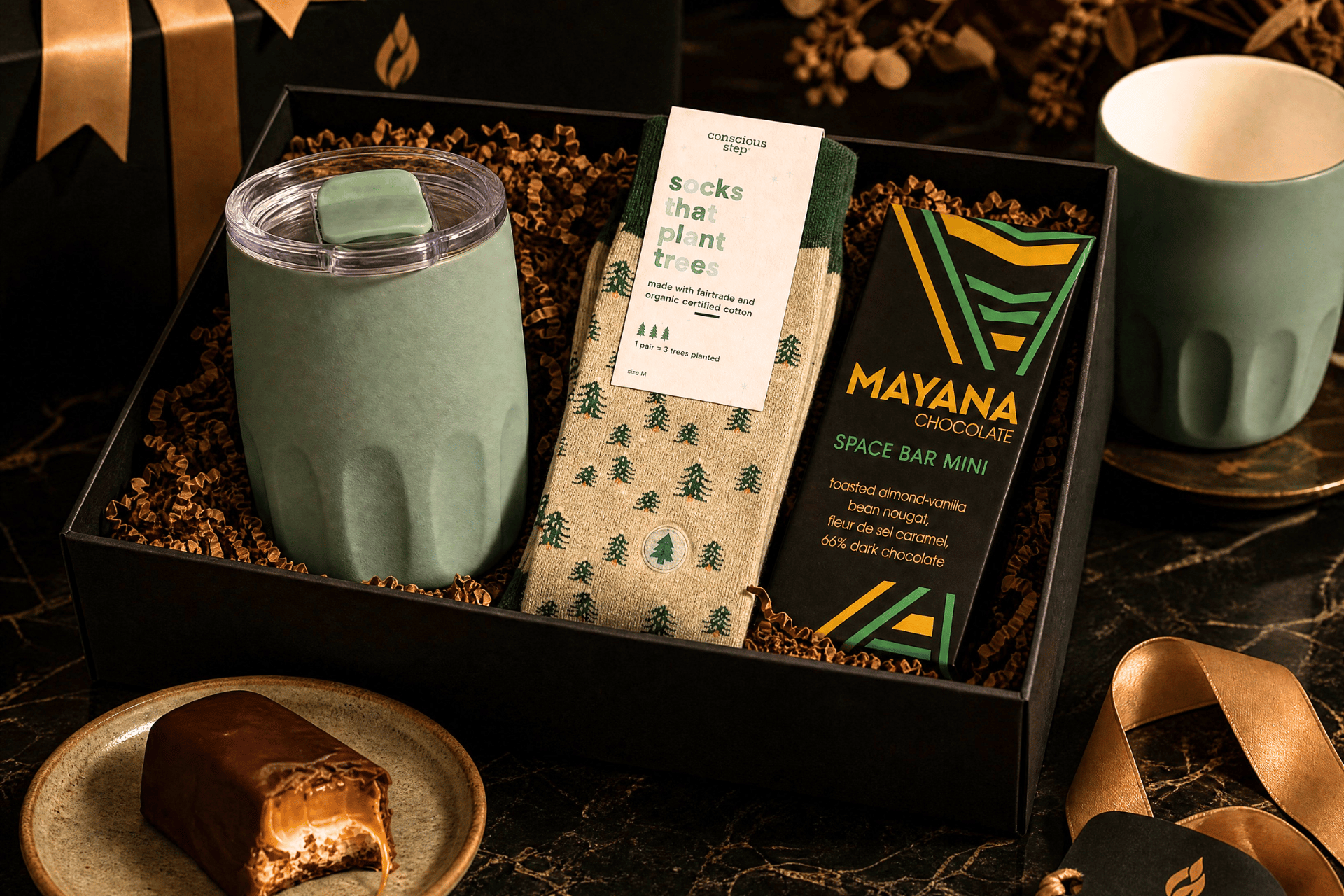 GiftSuite curated gift box with custom green tumbler, socks, and artisan chocolate