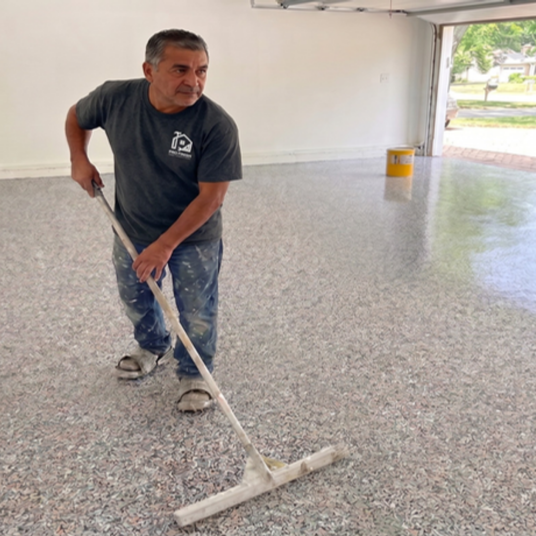 Worker applying topcoat to floor