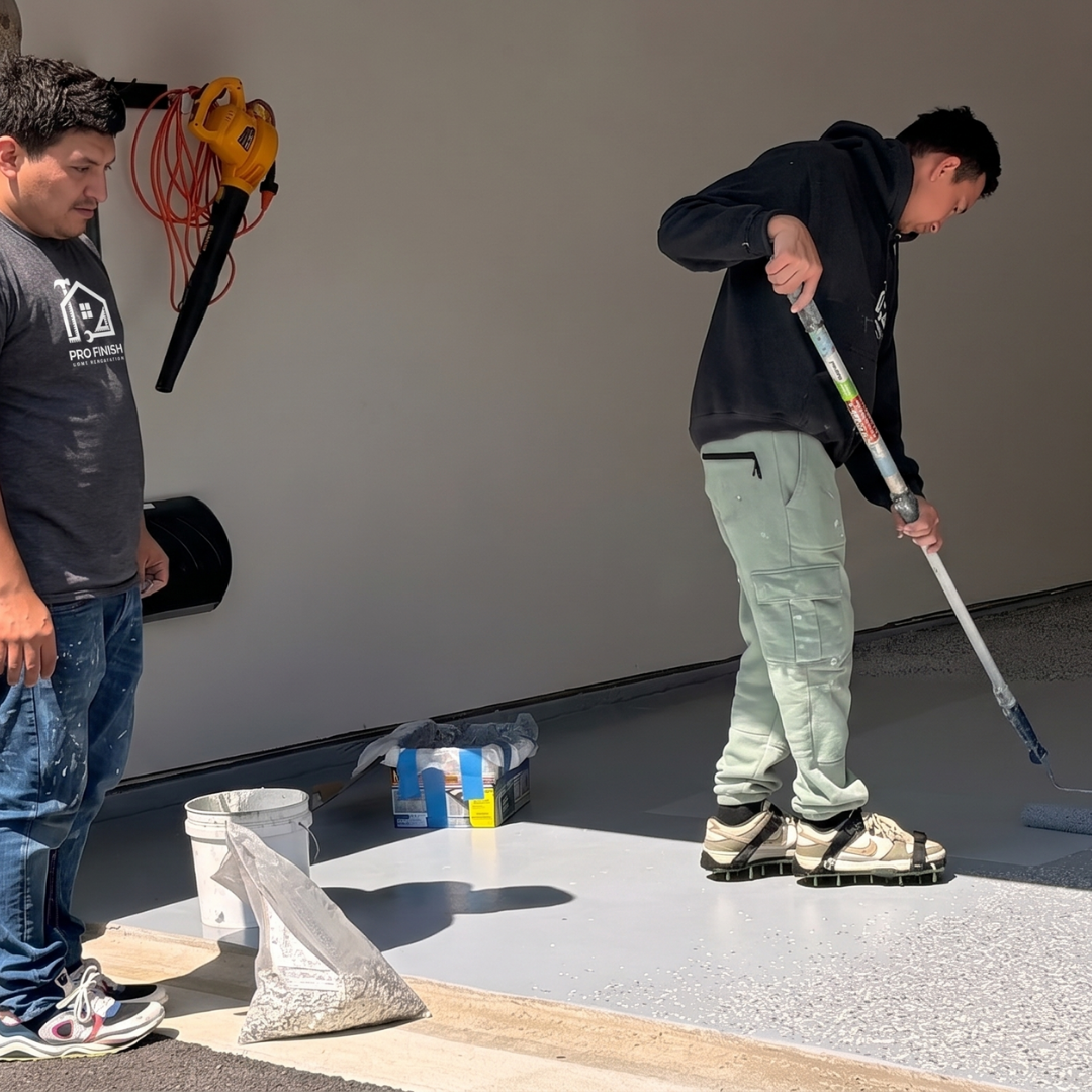 Workers applying floor coating