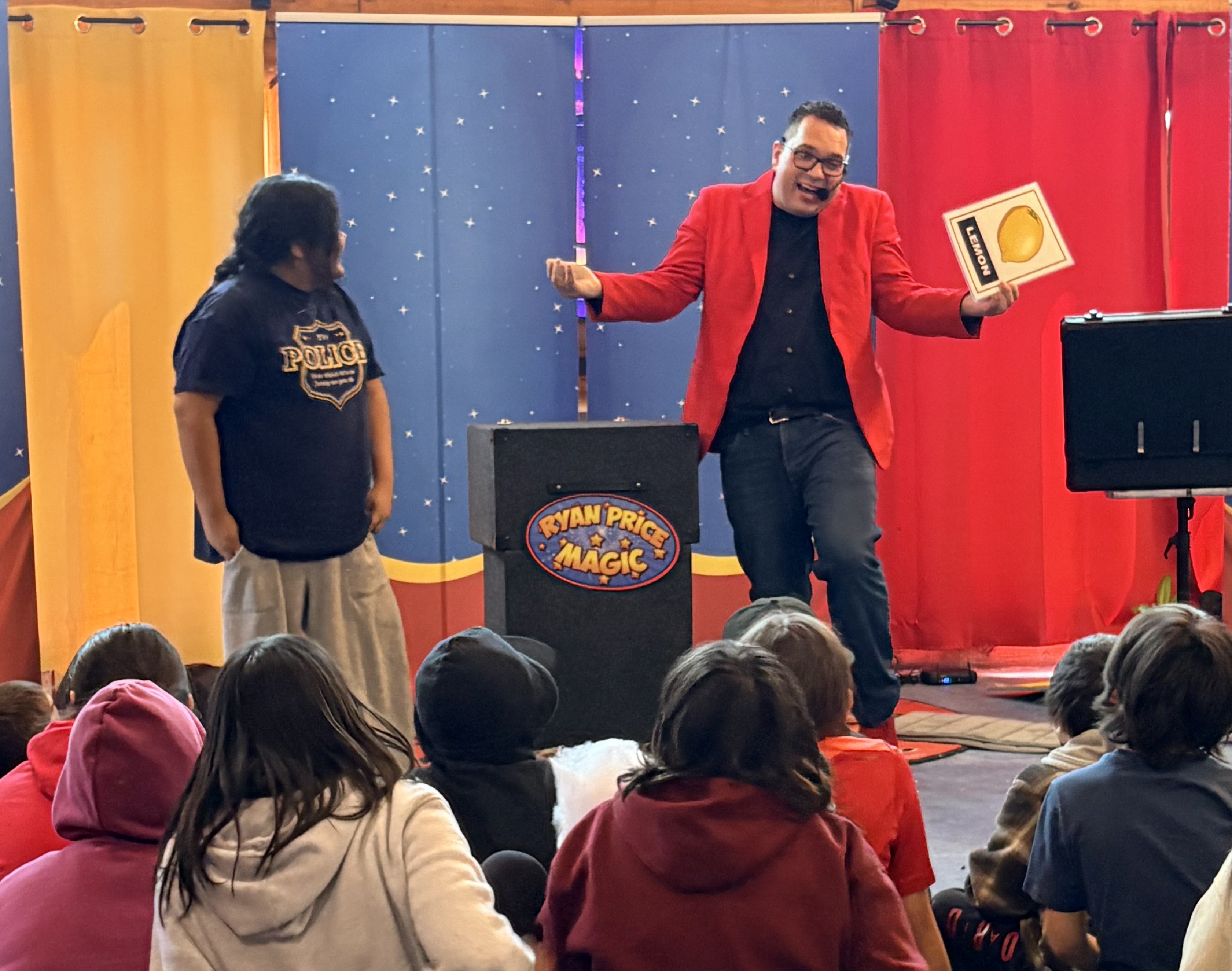 Ryan Price performing magic for children and families at an event in Winnipeg