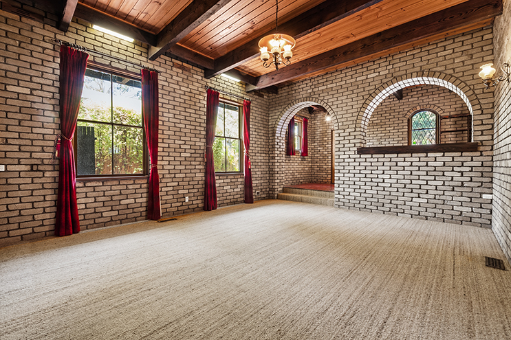 Empty brick room before virtual staging