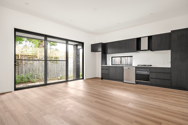 Empty kitchen and living area before virtual staging