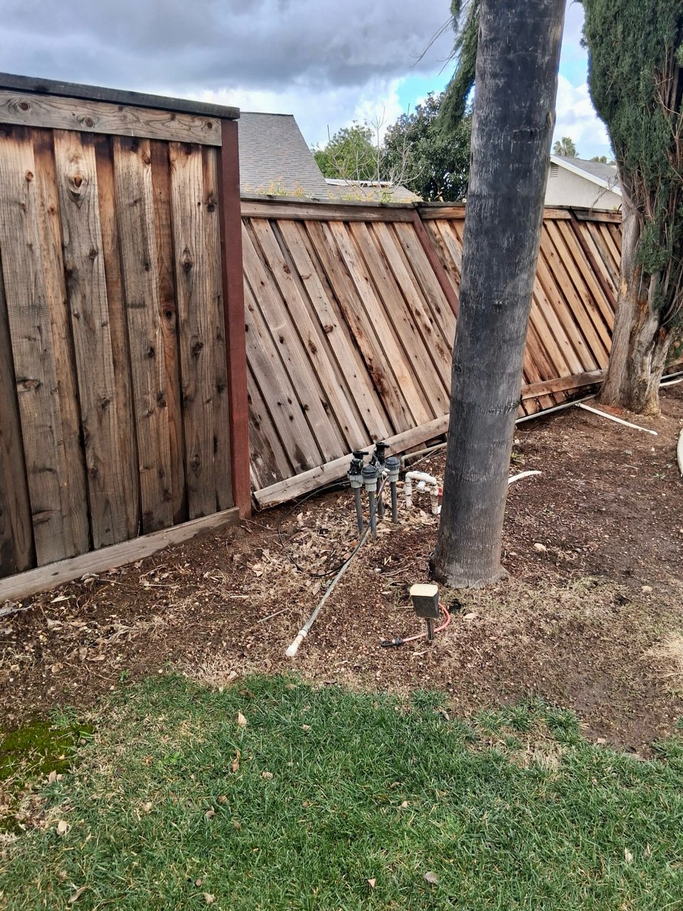 Damaged wooden fence in need of repair