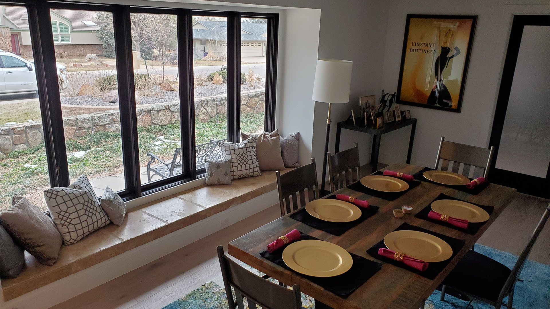 dining room with custom window-seat bench and new black-framed windows