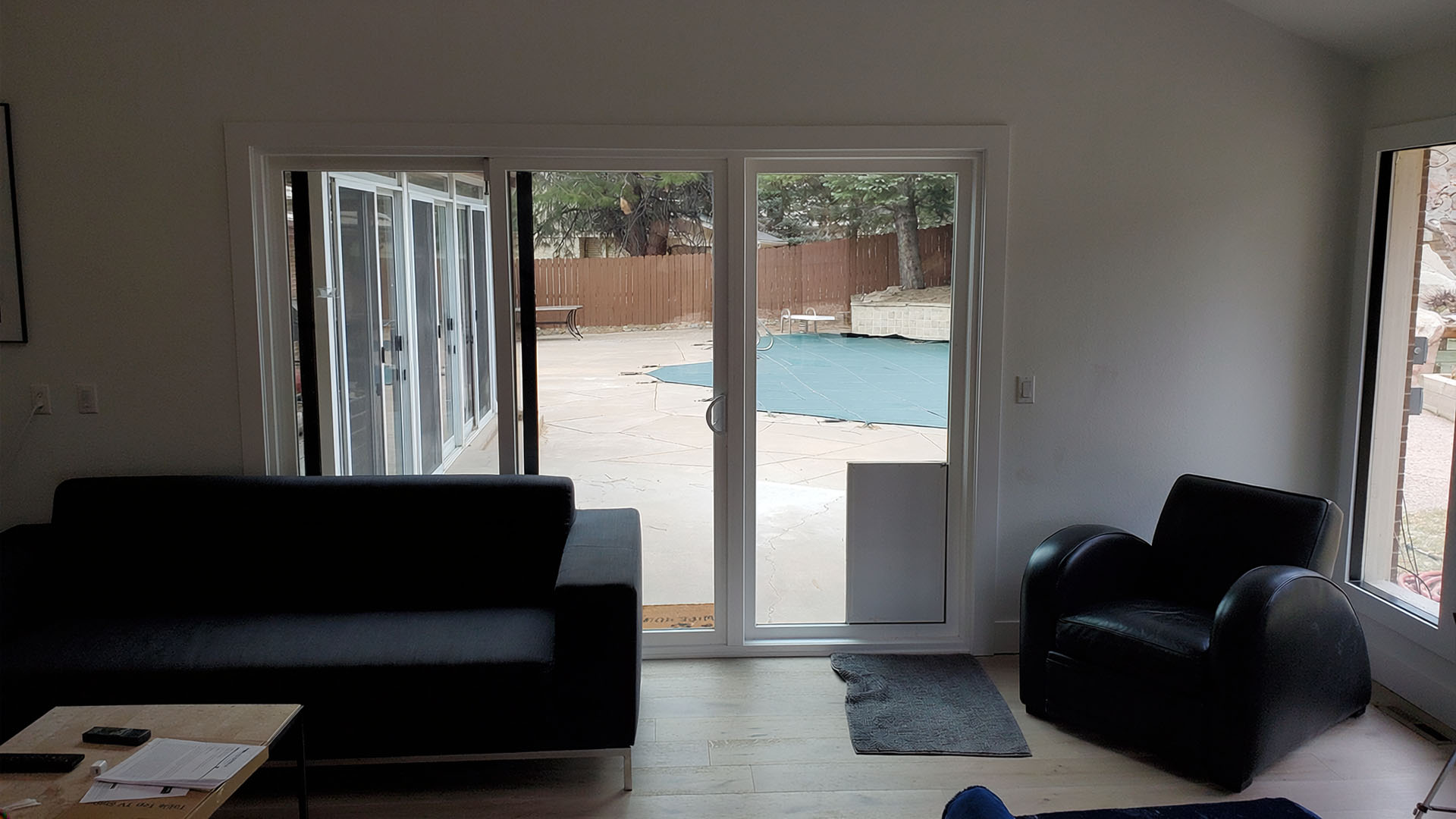 living room with new flooring and slider to backyard