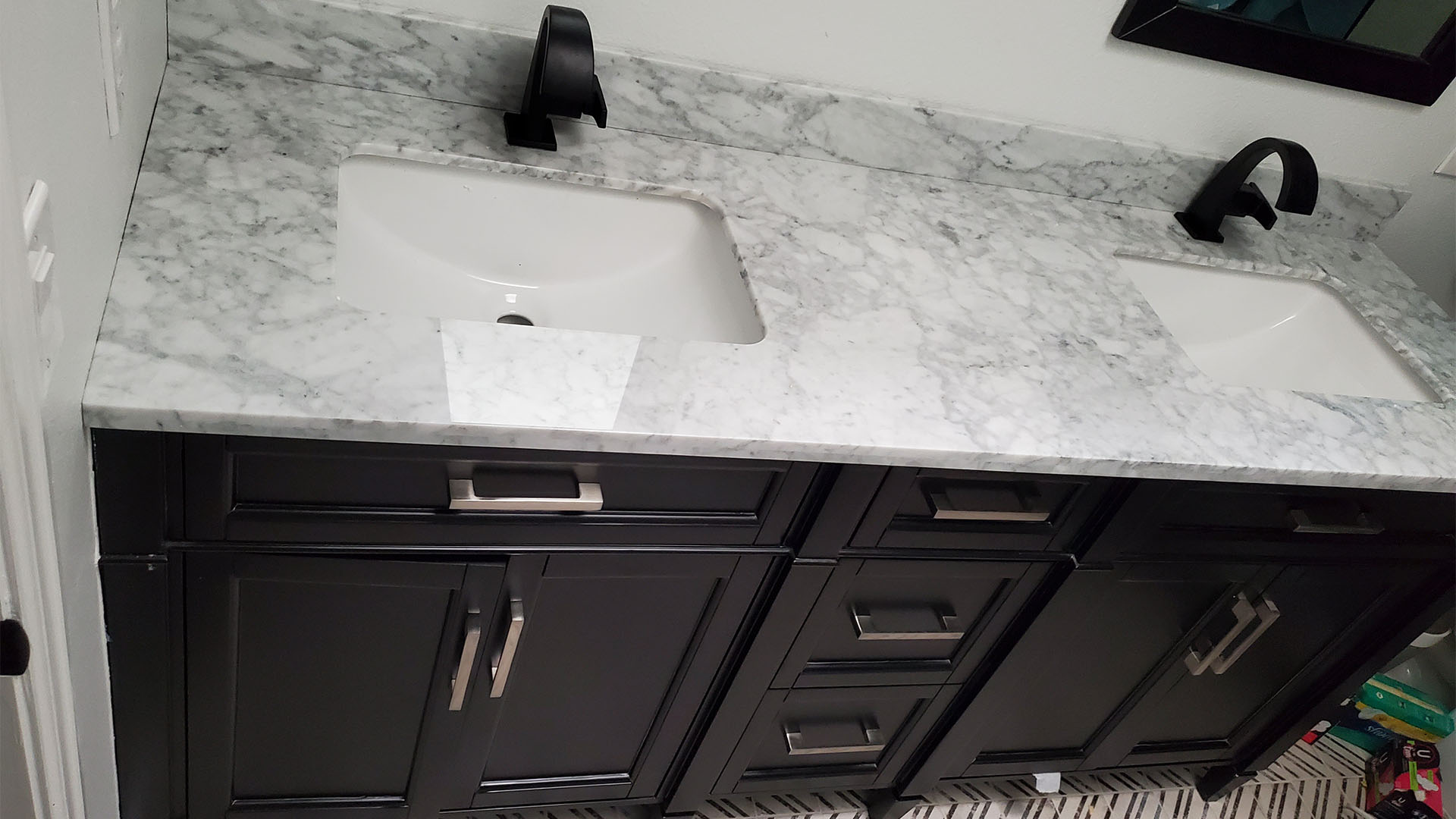 secondary bathroom with marble counter and matte-black fixtures