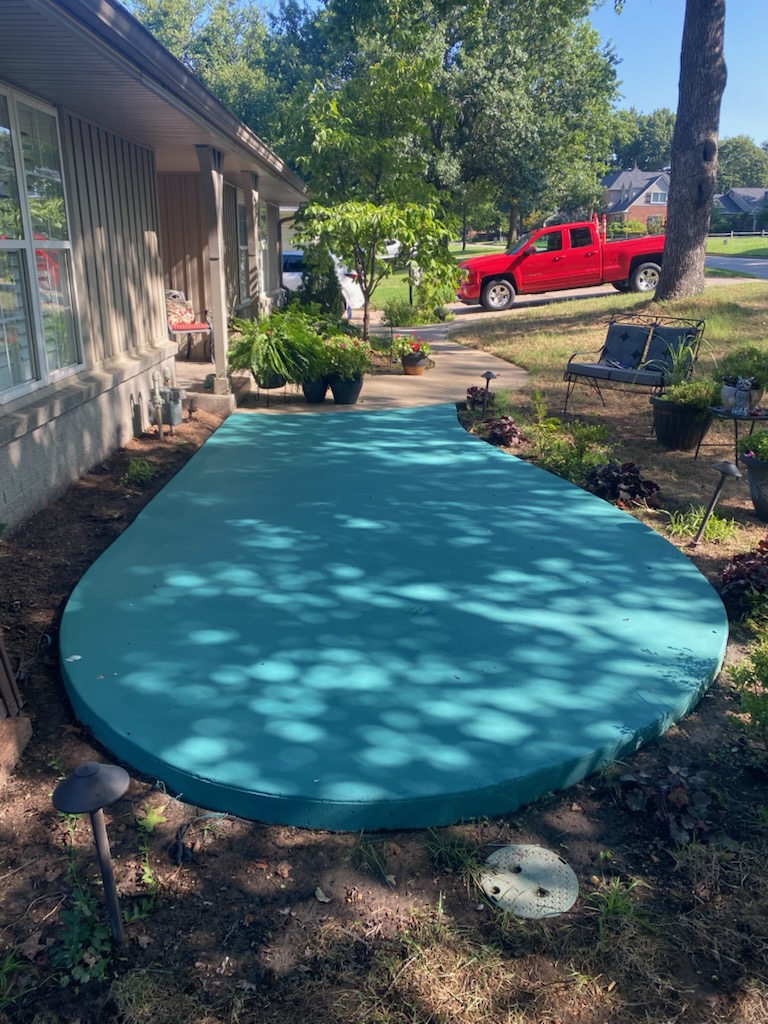 Unique custom-shaped and colored concrete slab providing a vibrant outdoor space.