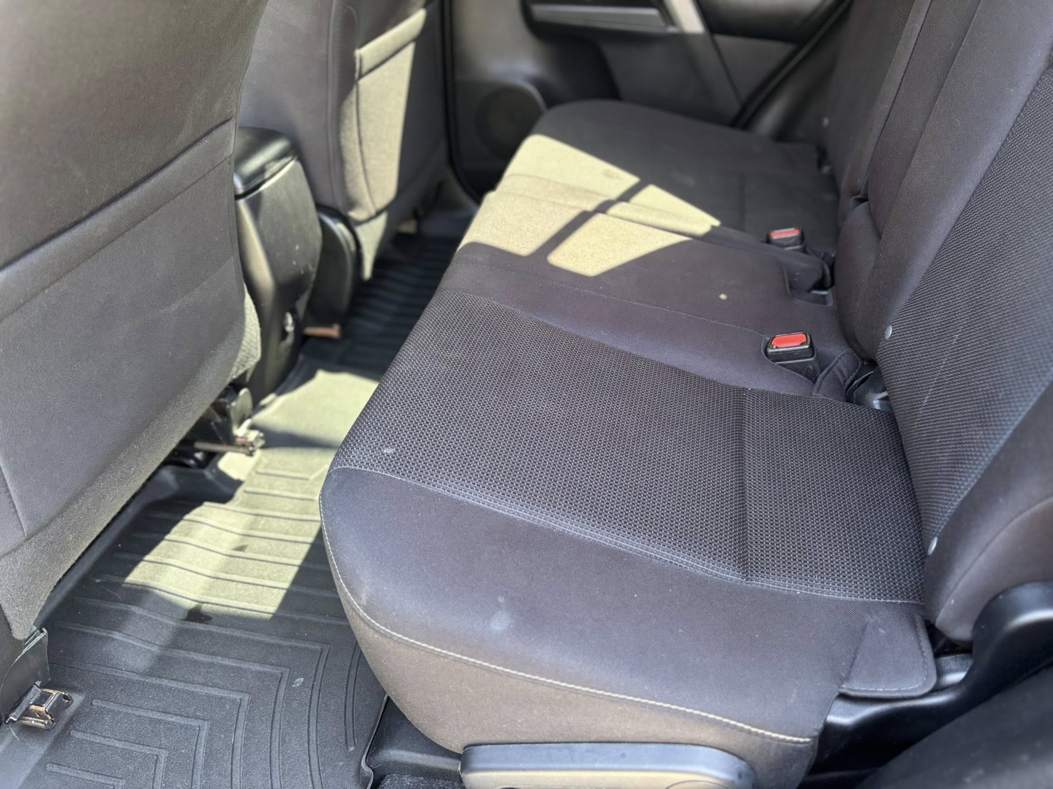 Spotless SUV rear seats with clean vacuum lines after interior detailing