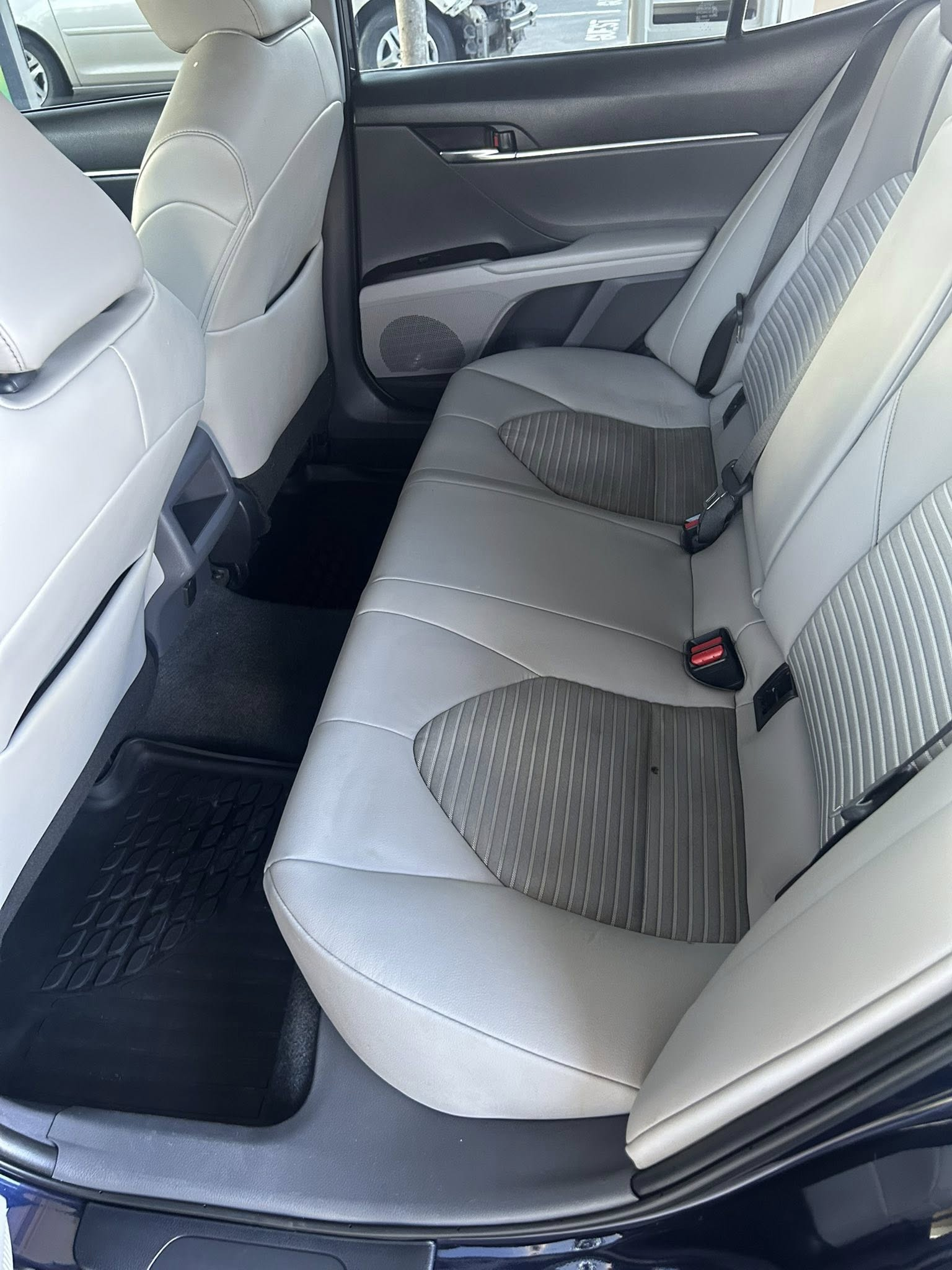 Spotless light leather rear car seats after stain extraction and interior detailing