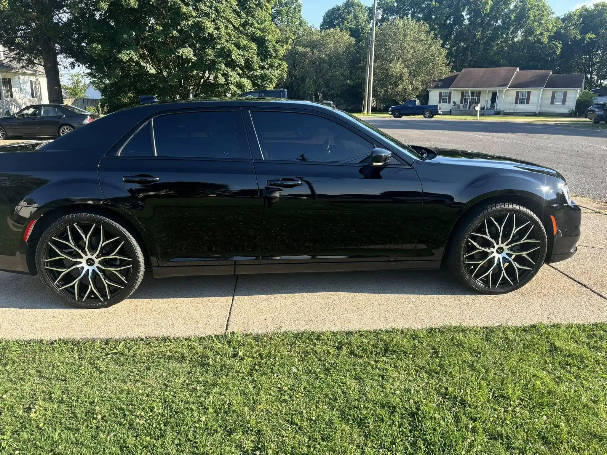 Freshly washed and waxed black sedan with glossy finish after mobile detailing