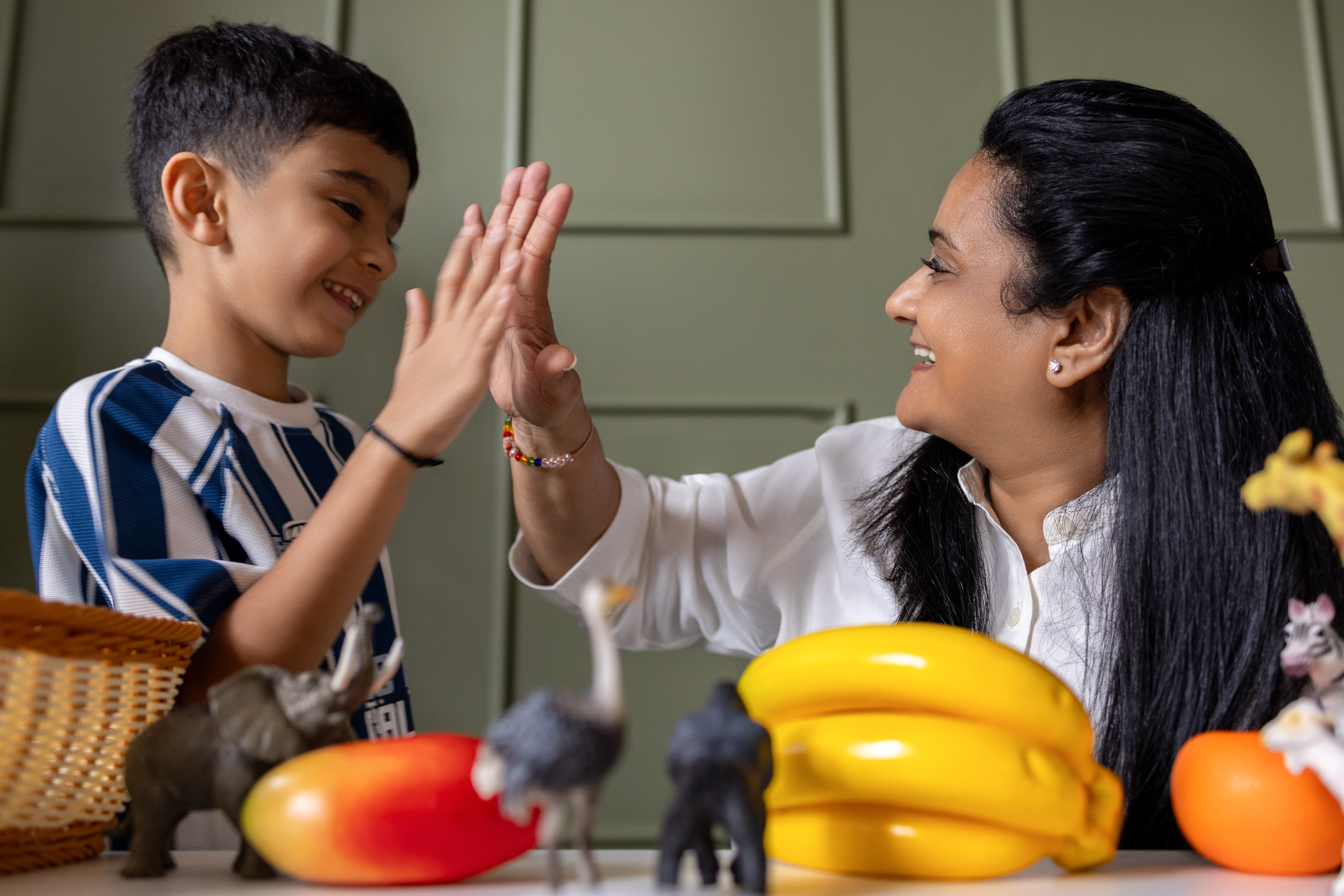 Diptii Mehta working 1:1 with a child mid-activity, providing specialized individual learning and SEN support