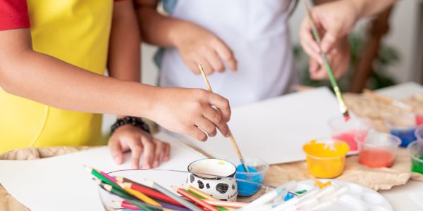Child expressing creativity and processing emotions through guided art therapy