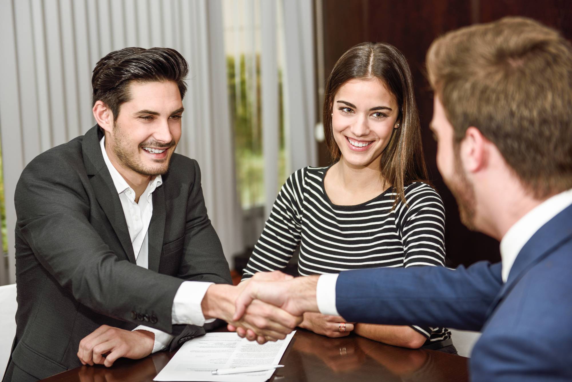 Professional bail bondsman shaking hands with clients, representing trust and reliable service in Spartanburg County, SC