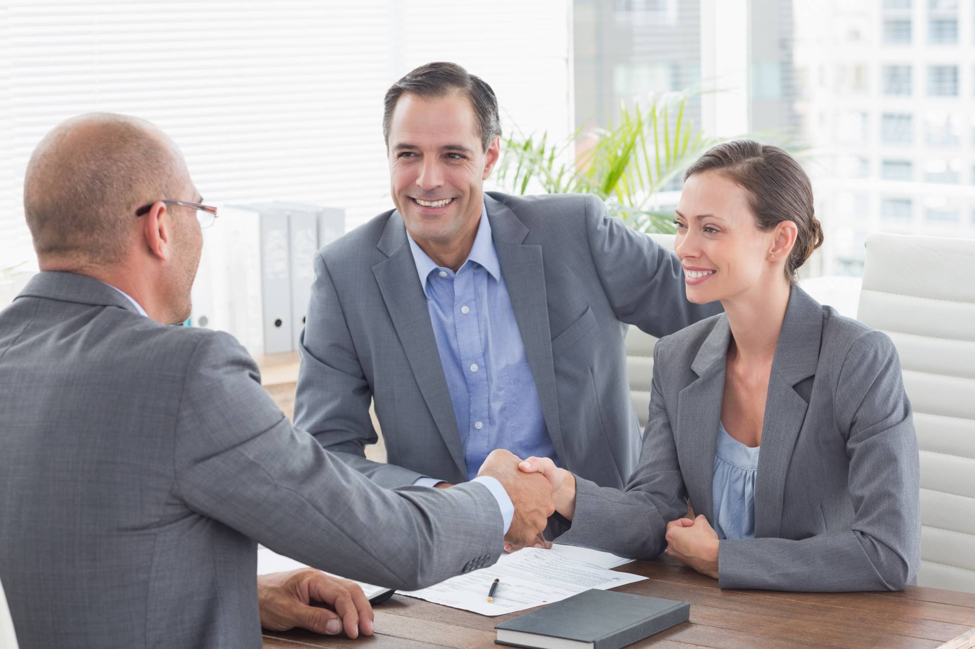 Professional bail bondsman shaking hands with clients, representing trust and reliable service in Spartanburg, SC