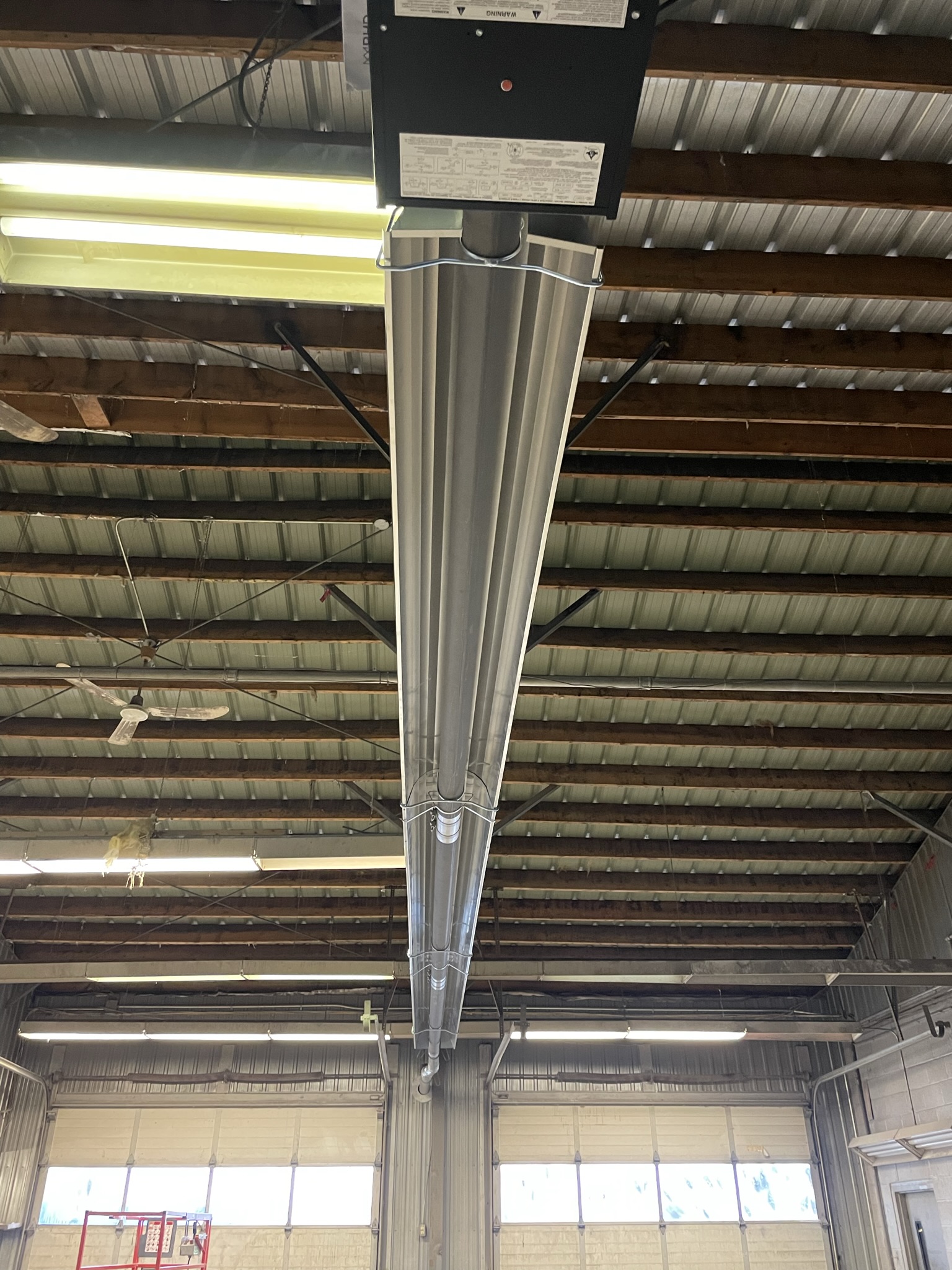 Commercial radiant tube heater installed on ceiling