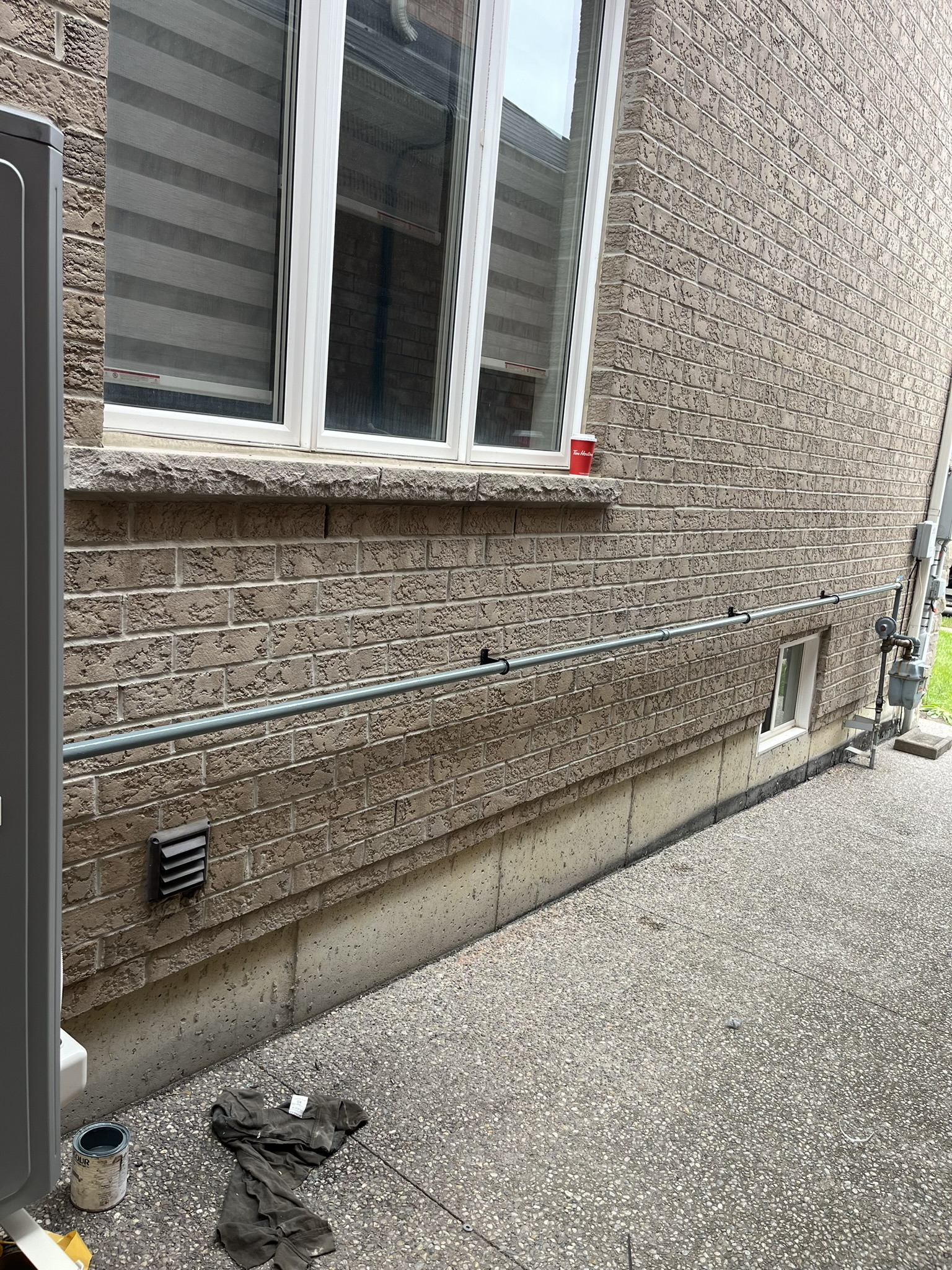 Clean gas line run along brick wall exterior
