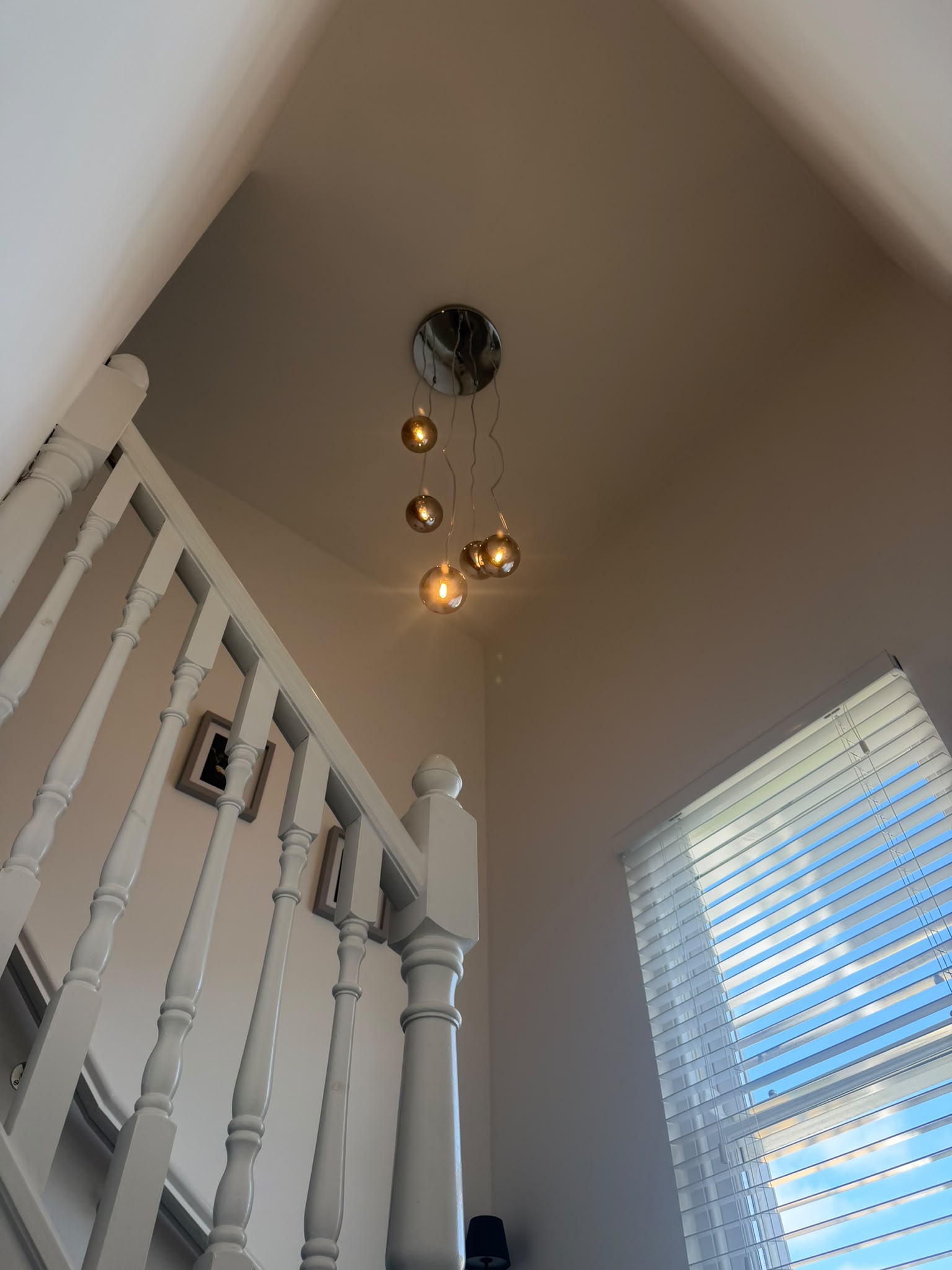 Warm glow looking up stairwell towards landing