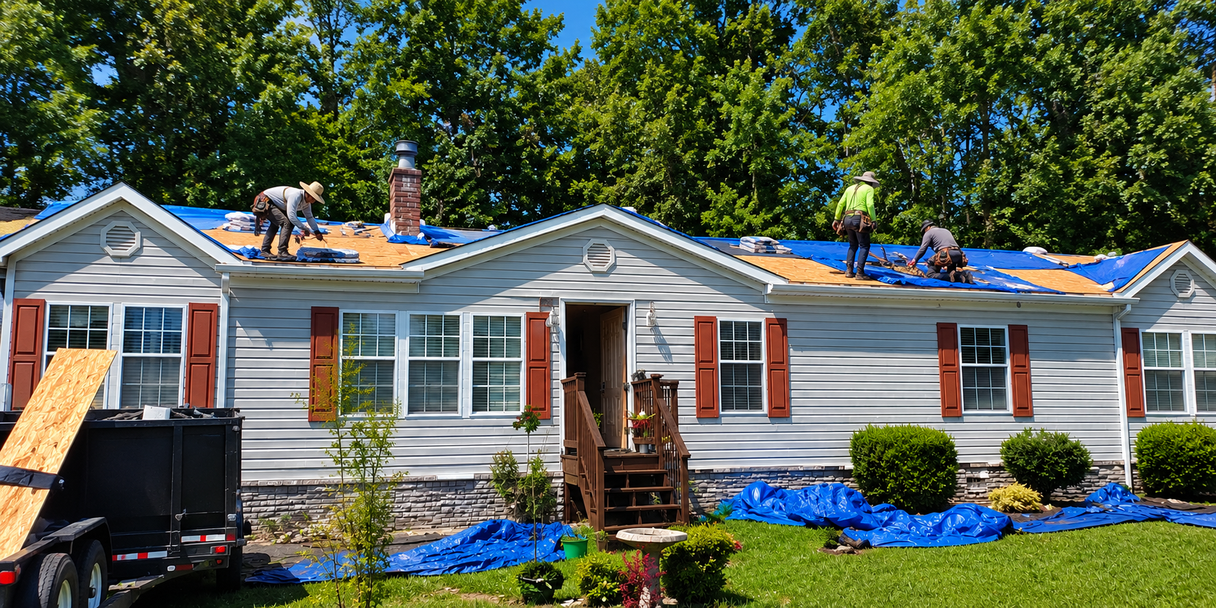 Worth Roofing Company crew professionally installing an emergency blue tarp on a storm-damaged residential roof in Middle Tennessee