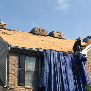 Complete Roof Tear-Off - Professional roof tear-off and replacement in progress, protecting the home's exterior.