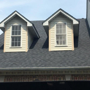 Dormer Roof Replacement - Detailed roofing work around dormer windows ensuring perfect seals and clean lines.