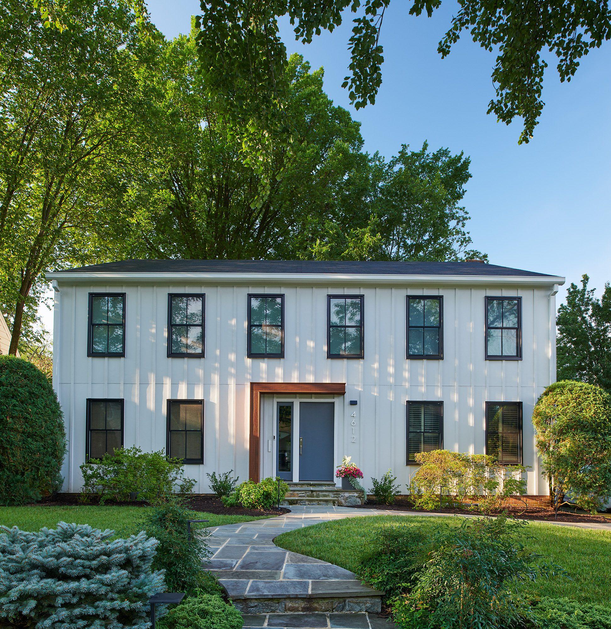 Board and Batten Siding - Modern farmhouse style board and batten white siding with black window frames.