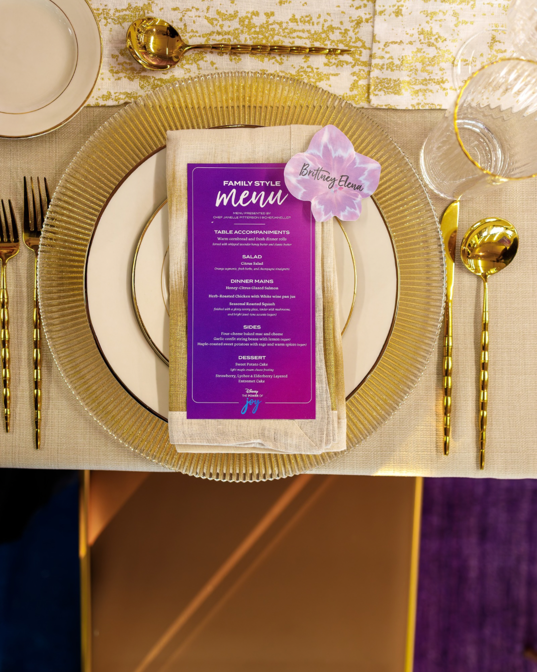 Curated gala table setting with gold cutlery and custom event menu