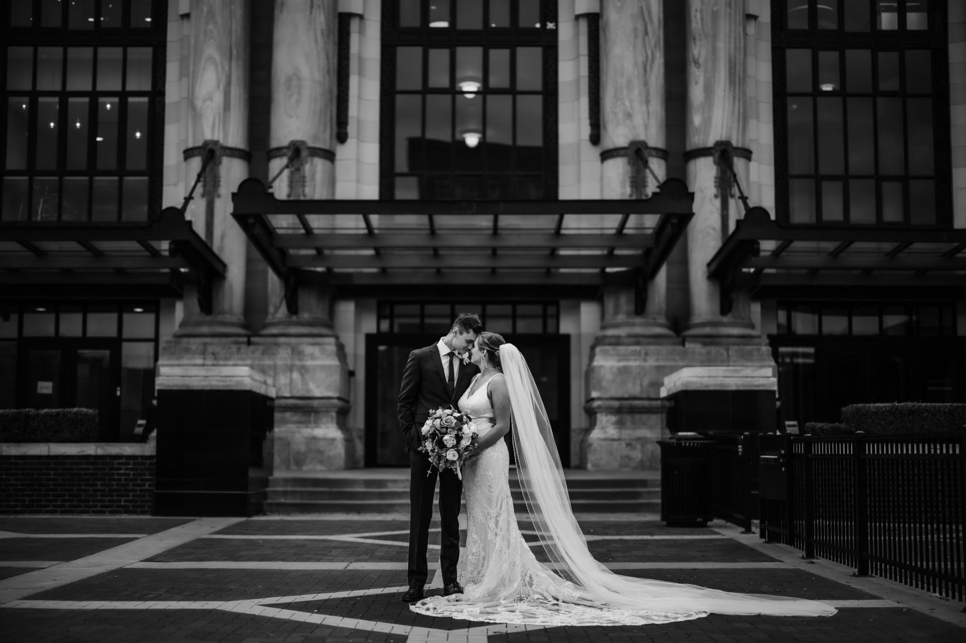 Wedding couple portrait at building entrance