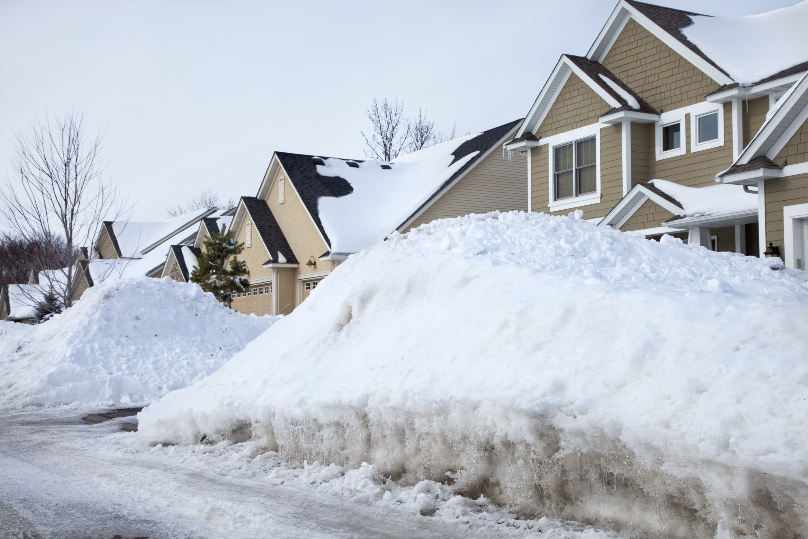 Snow piles in front of houses