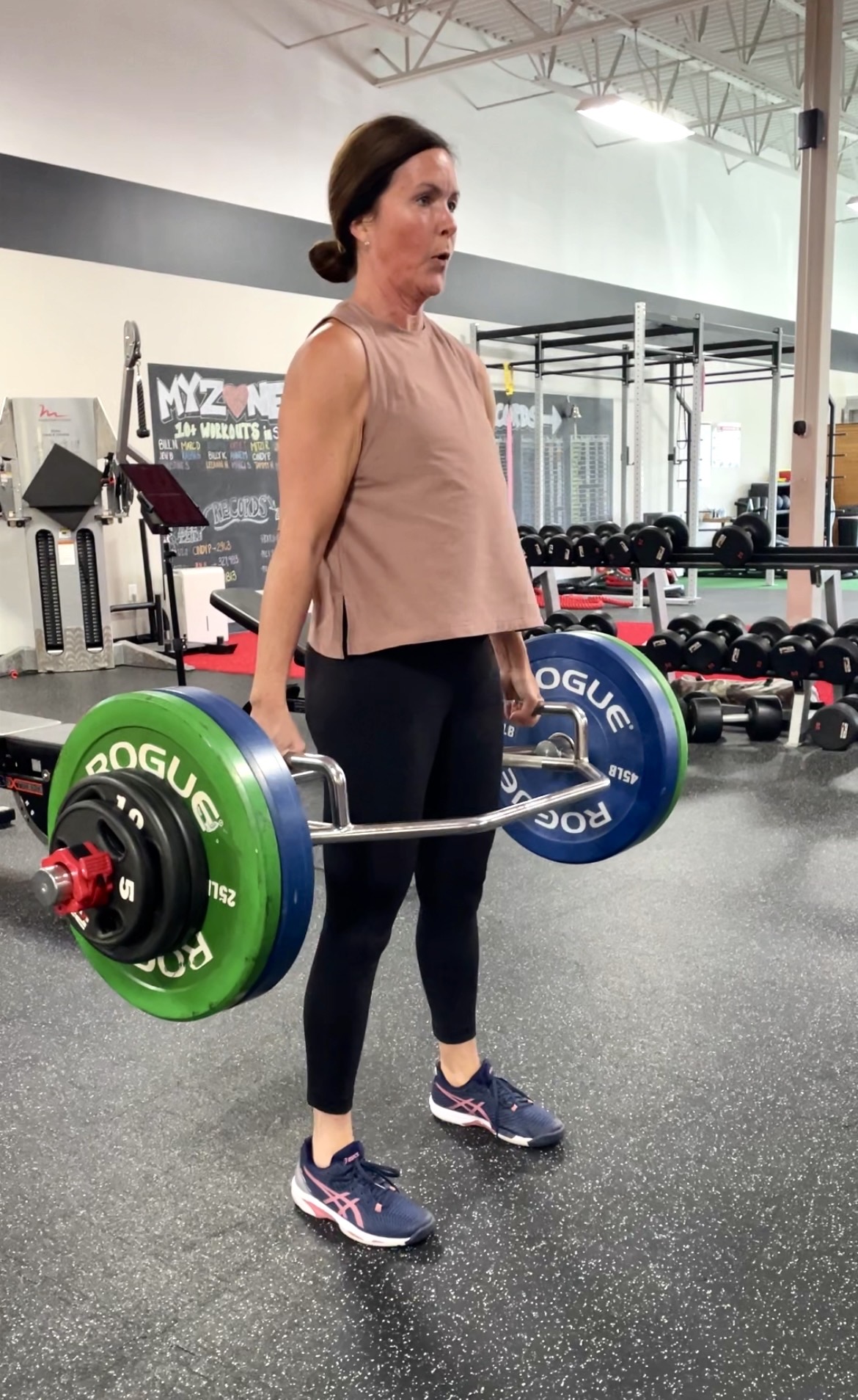 Jennifer, RxD member for 12+ years, performing a hex bar deadlift at Results by Design Fitness