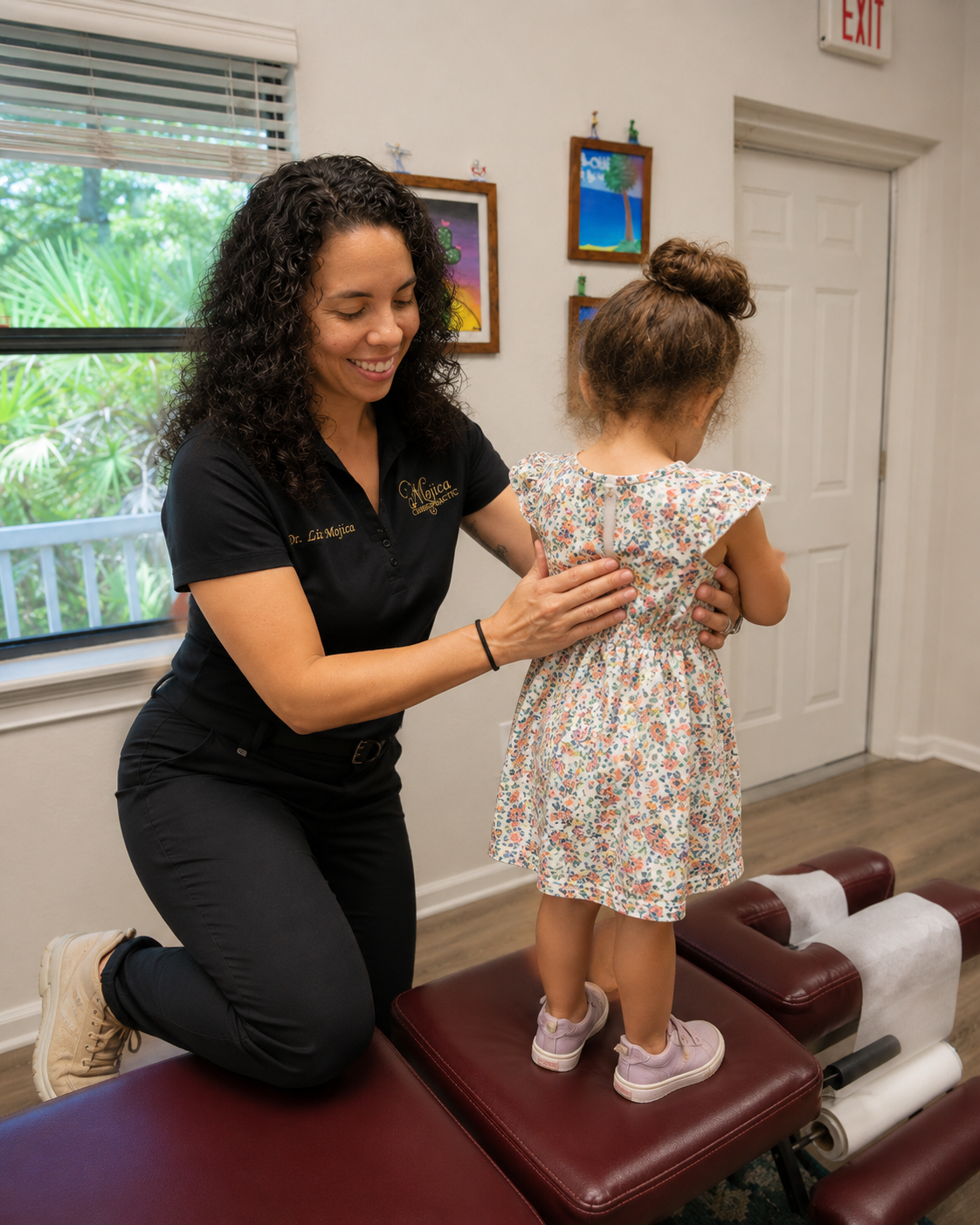 Dr. Liz providing gentle pediatric chiropractic evaluation in the Mojica Chiropractic Care office