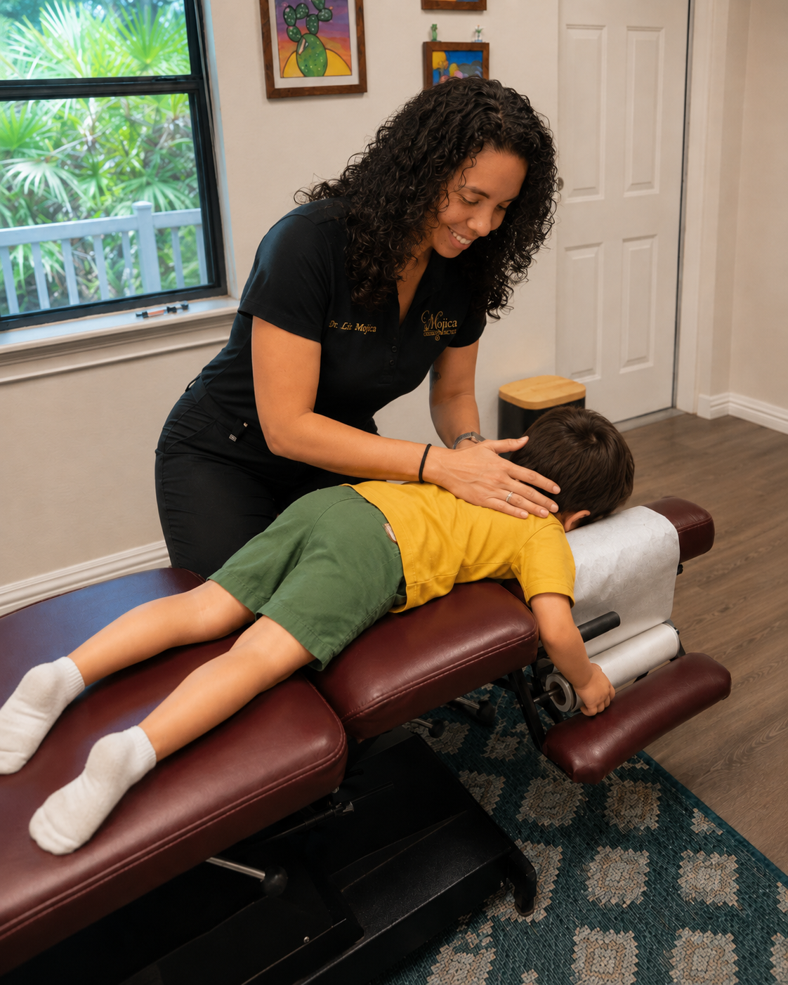 Dr. Liz assessing postural mobility and spinal alignment for a young girl at Mojica Chiropractic Care