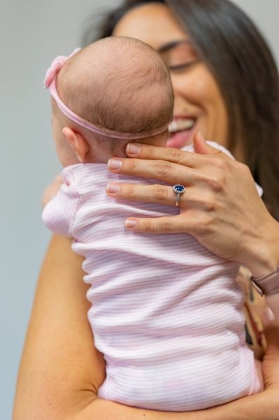 Dr. Liz holding an infant gently supporting the head and neck at Mojica Chiropractic Care