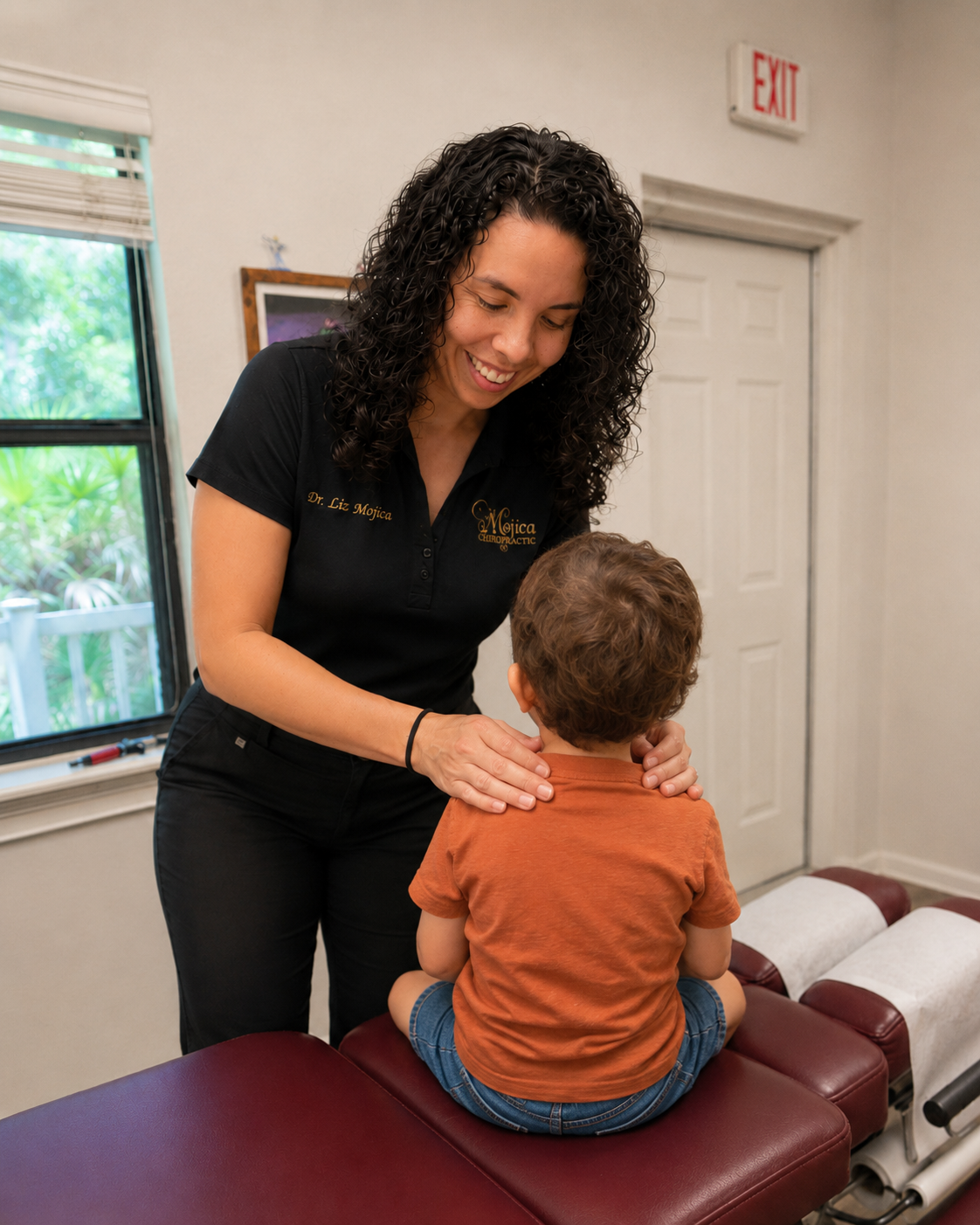 Dr. Liz assessing spinal mobility and motor interaction for a young patient at Mojica Chiropractic Care
