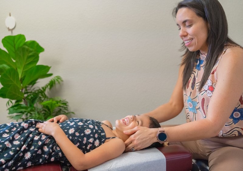 Dr. Liz adjusting a child patient at Mojica Chiropractic Care