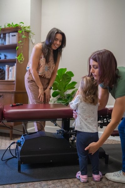 Dr. Liz with child in office