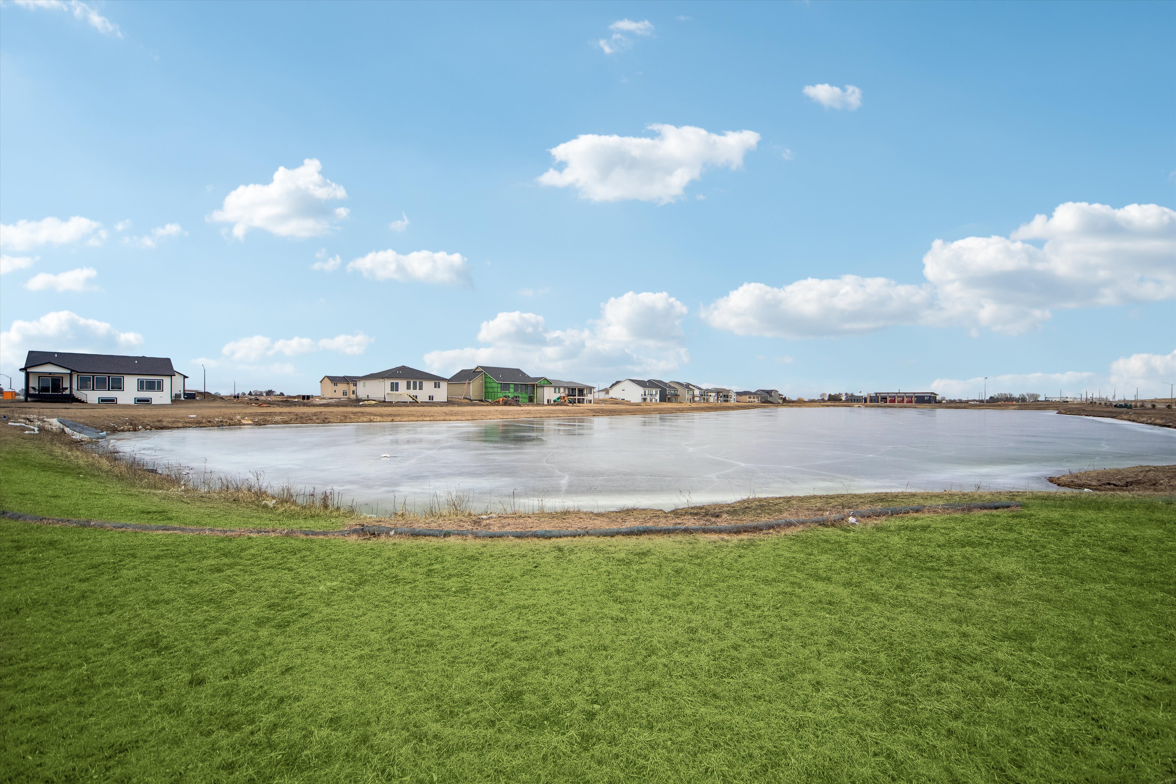 Community pond with homes