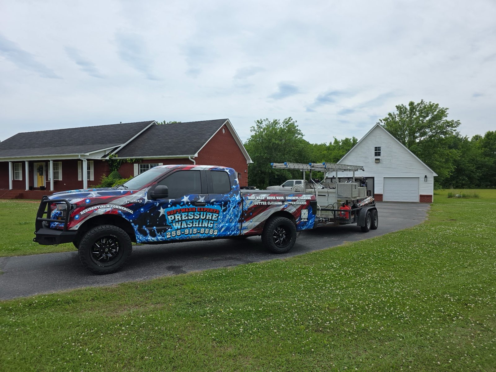 Softwash Experts truck and trailer at a residential job in Cullman AL