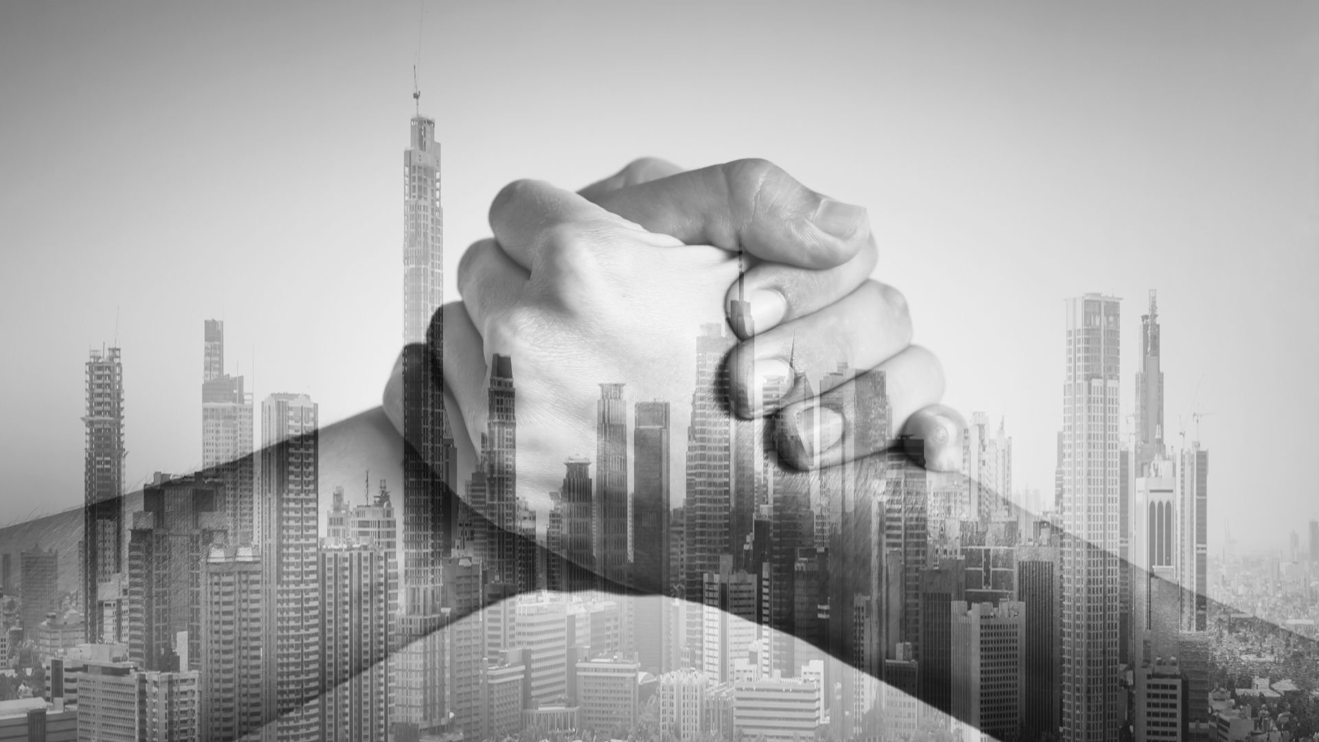 Image of two people shaking hands as if making amends