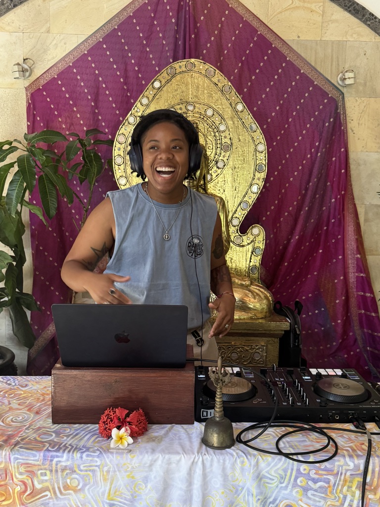 Destinē, known as DJ Promise, on the decks leading an ecstatic dance set