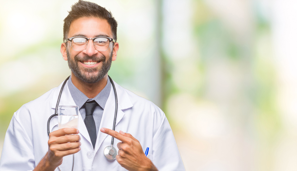 Doctor holding a glass of water