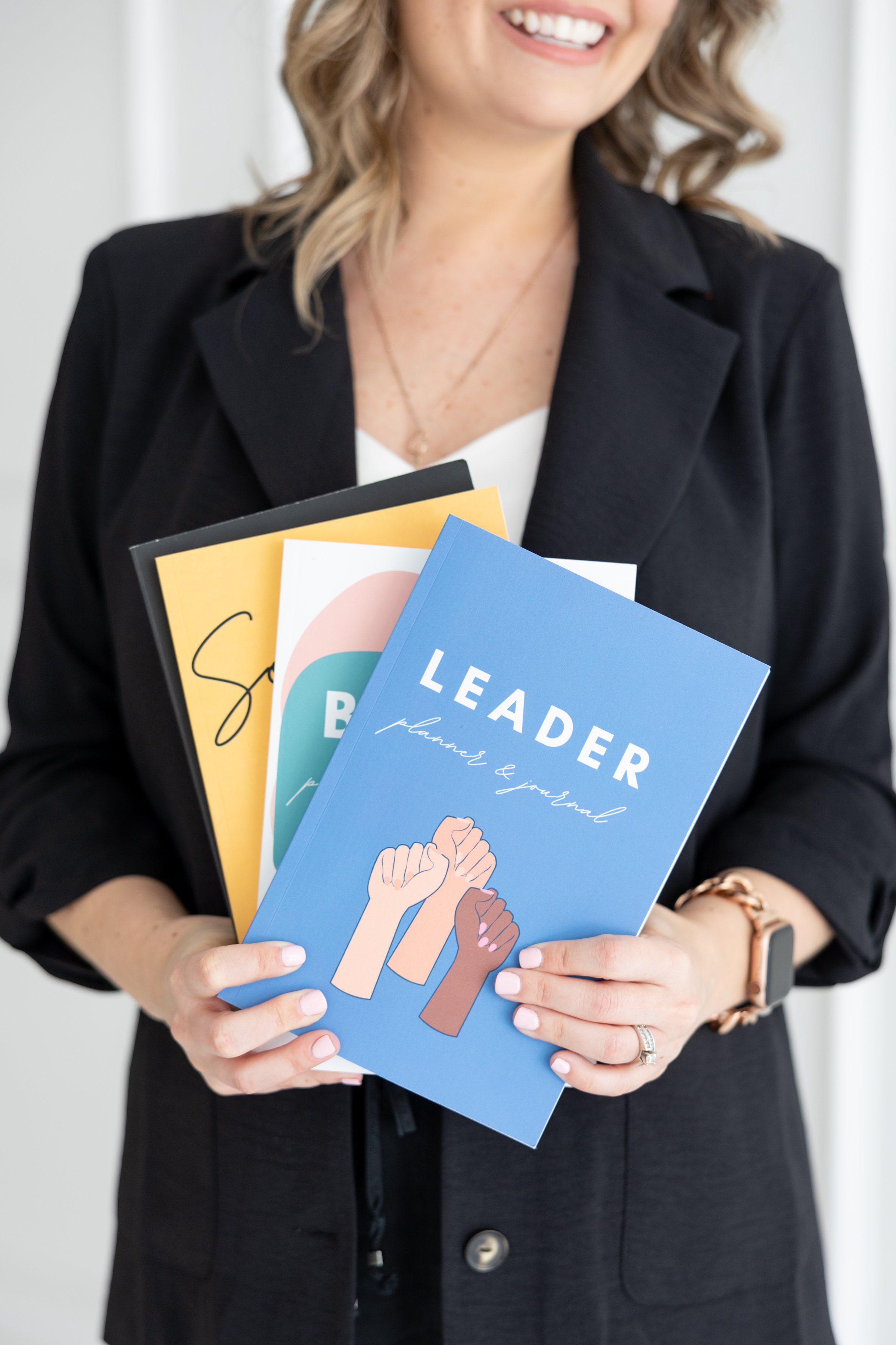Angela holding journals and planners