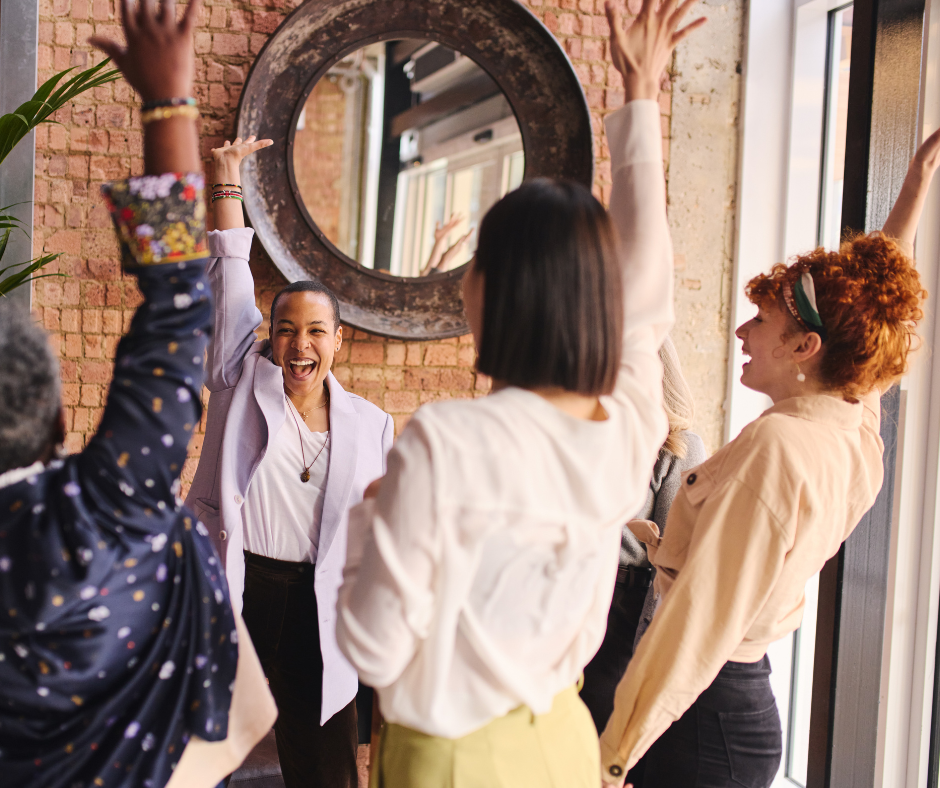 Women celebrating in front of a mirror